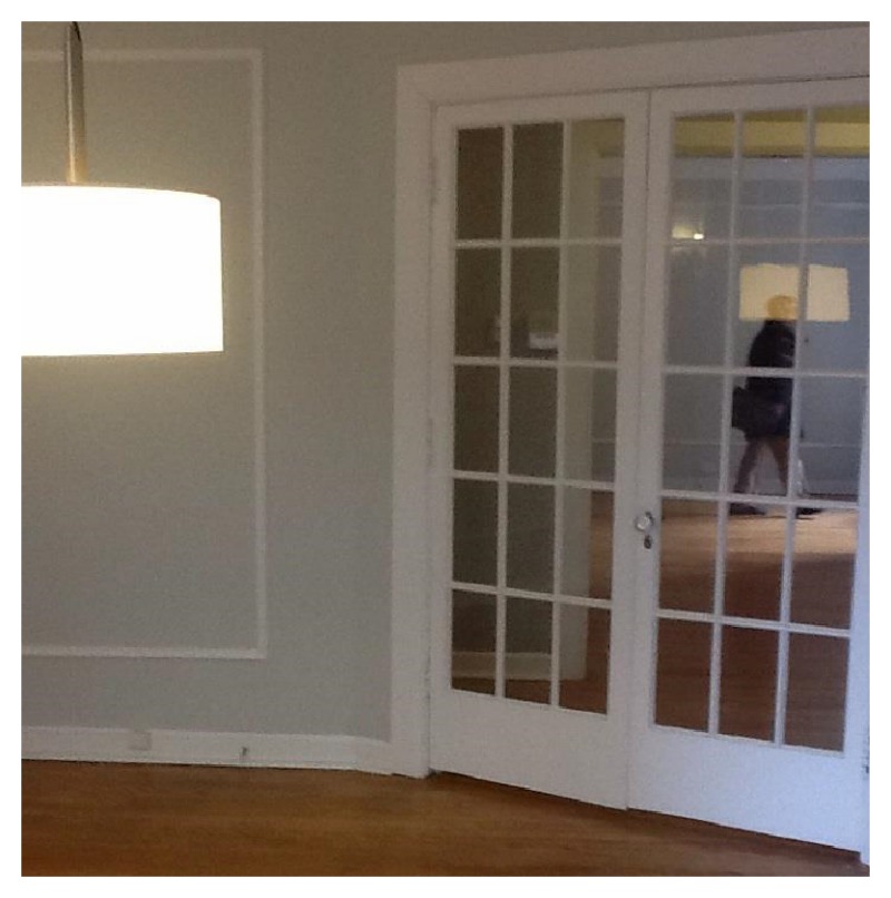 Nomad Luxuries a photo of white glass french doors separating the foyer and dining area. 