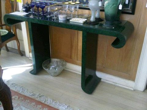 Nomad Luxuries showcasing an emerald green antique table. 