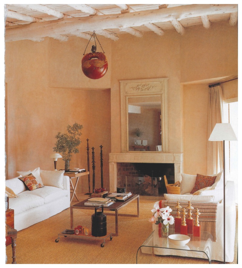 Nomad Luxuries an inspirational photo of a warm toned, simple Idyllic living room filled with natural light. 