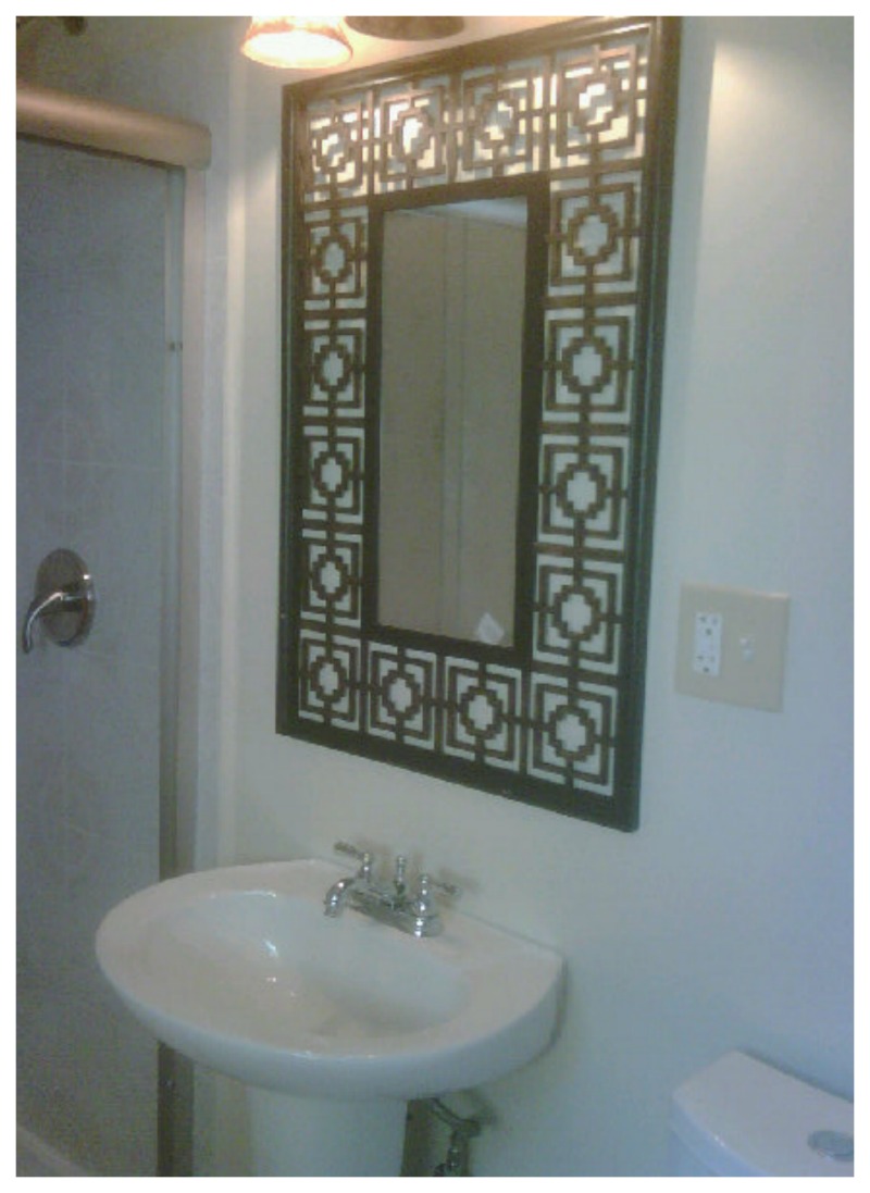 Nomad Luxuries a geometric and intricately decorated mirror for the bathroom. 