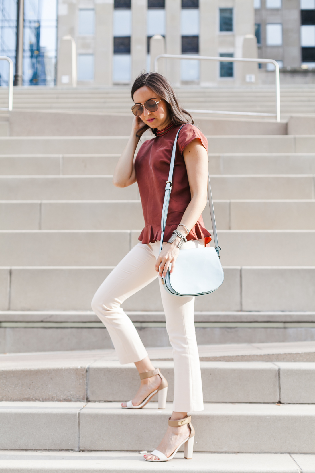 Nomad Luxuries Yana Puaca wearing a rust ruffled top and pink pants in chicago summer
