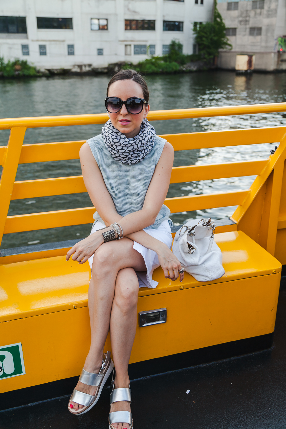 NoMad Luxuries wearing a white denim skirt and a blue linen top in Chicago on the water taxi in the Summer