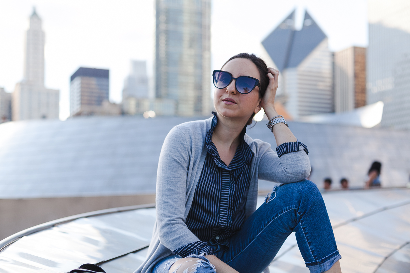 Yana Puaca of NoMad Luxuries wearing a striped shirt and sweater from Banana Republic in Chicago for Fall