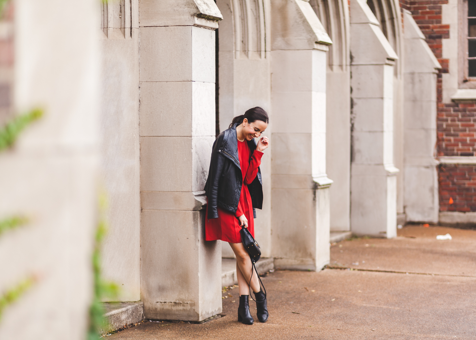 Yana Frigelis from NoMad Luxuries wearing a red dress and leather moto jacket for the fall for an edgy and feminine look from Zara 