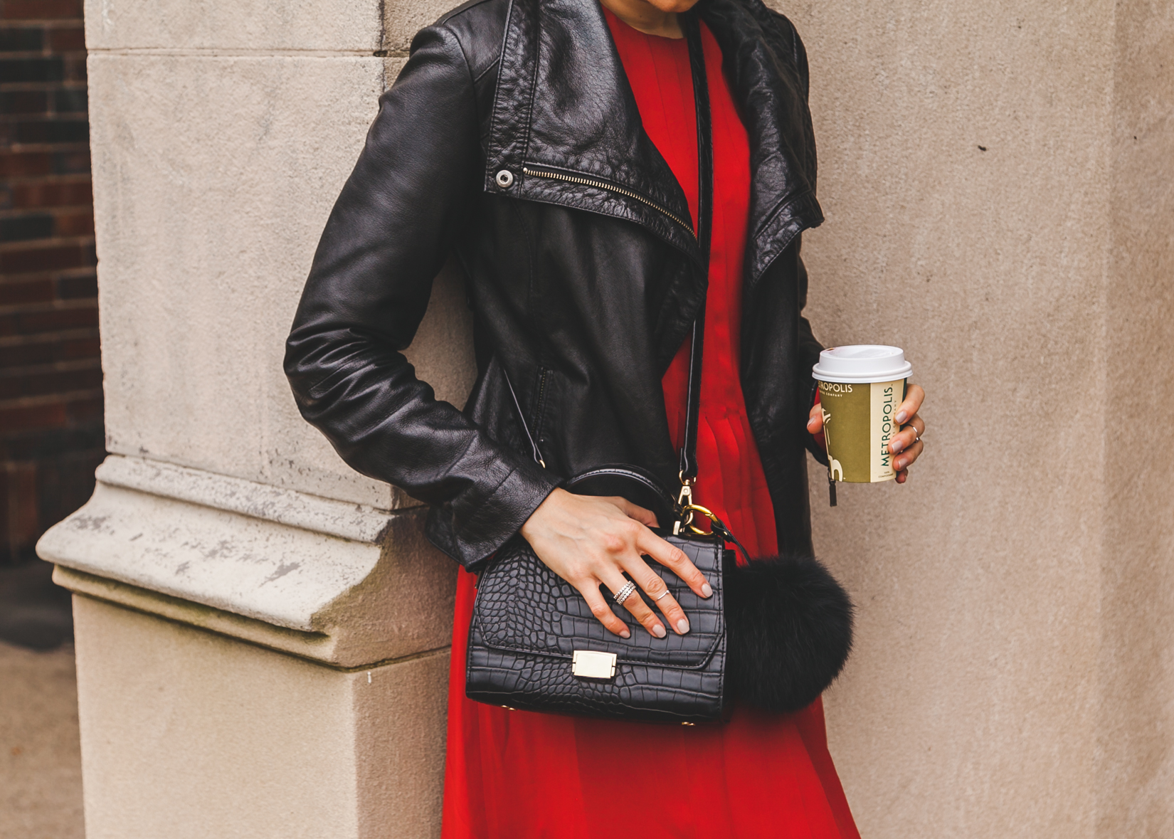 Yana Frigelis from NoMad Luxuries wearing a red dress and leather moto jacket for the fall for an edgy and feminine look from Zara 