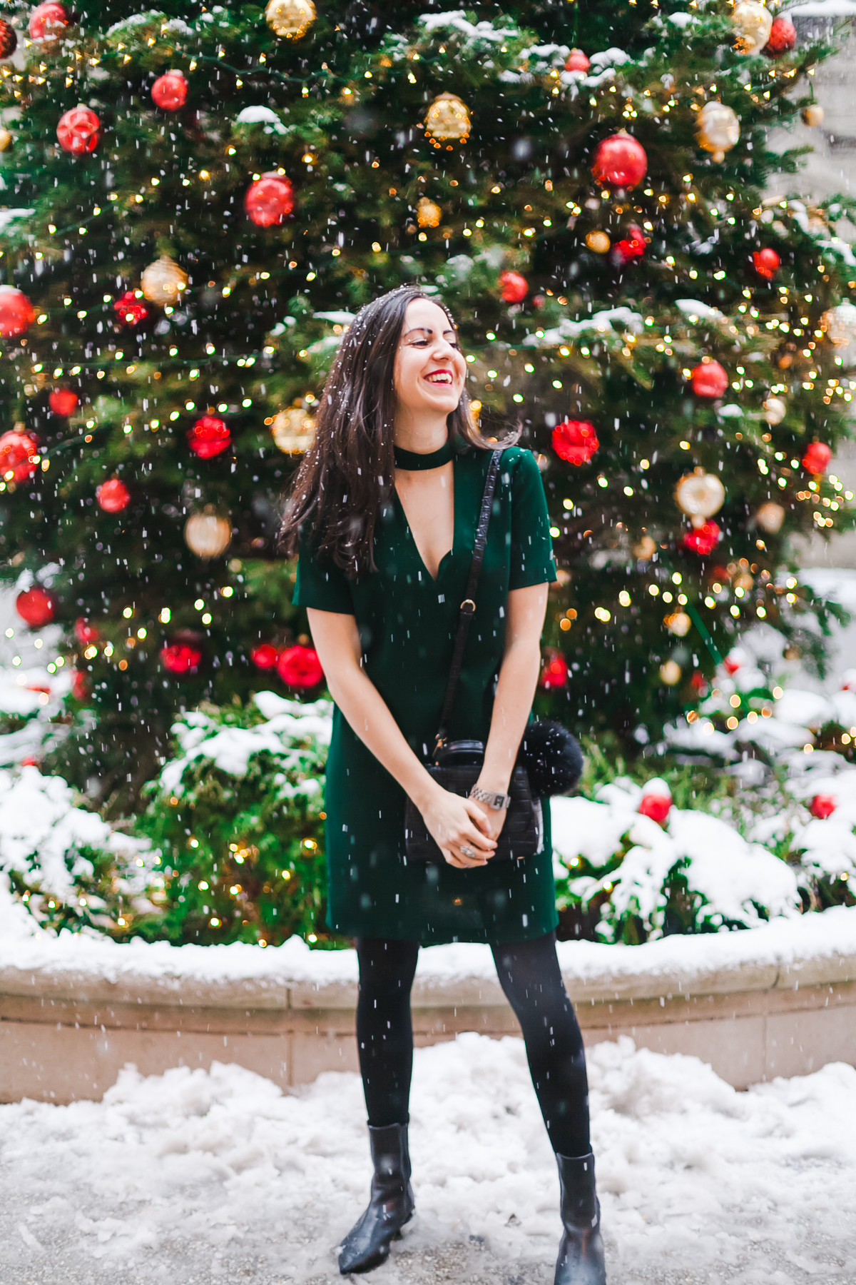 Yana Frigelis of NoMad Luxuries wears a green cocktail dress from zara and a fur scarf from asos for the holidays 