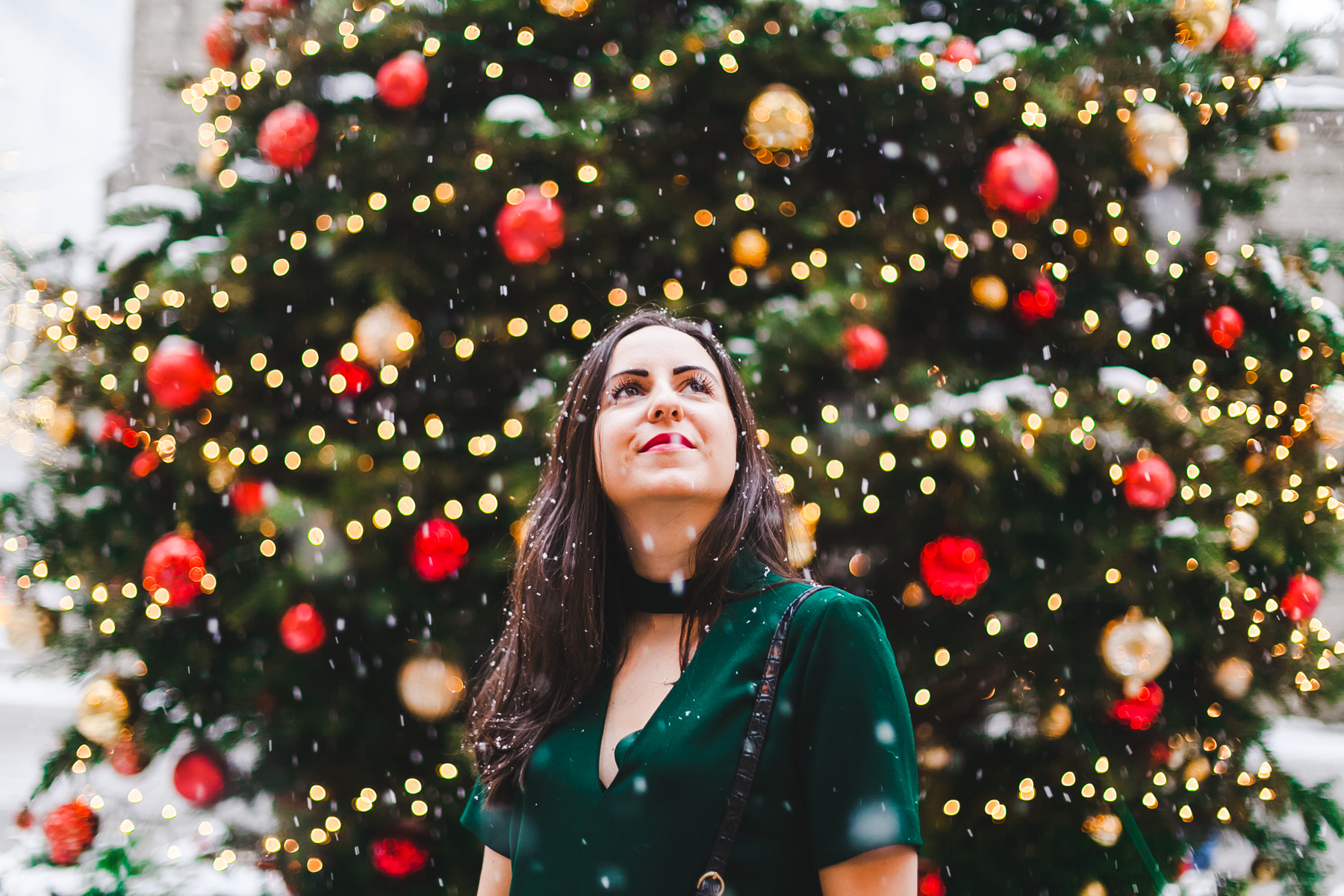 Yana Frigelis of NoMad Luxuries wears a green cocktail dress from zara and a fur scarf from asos for the holidays 