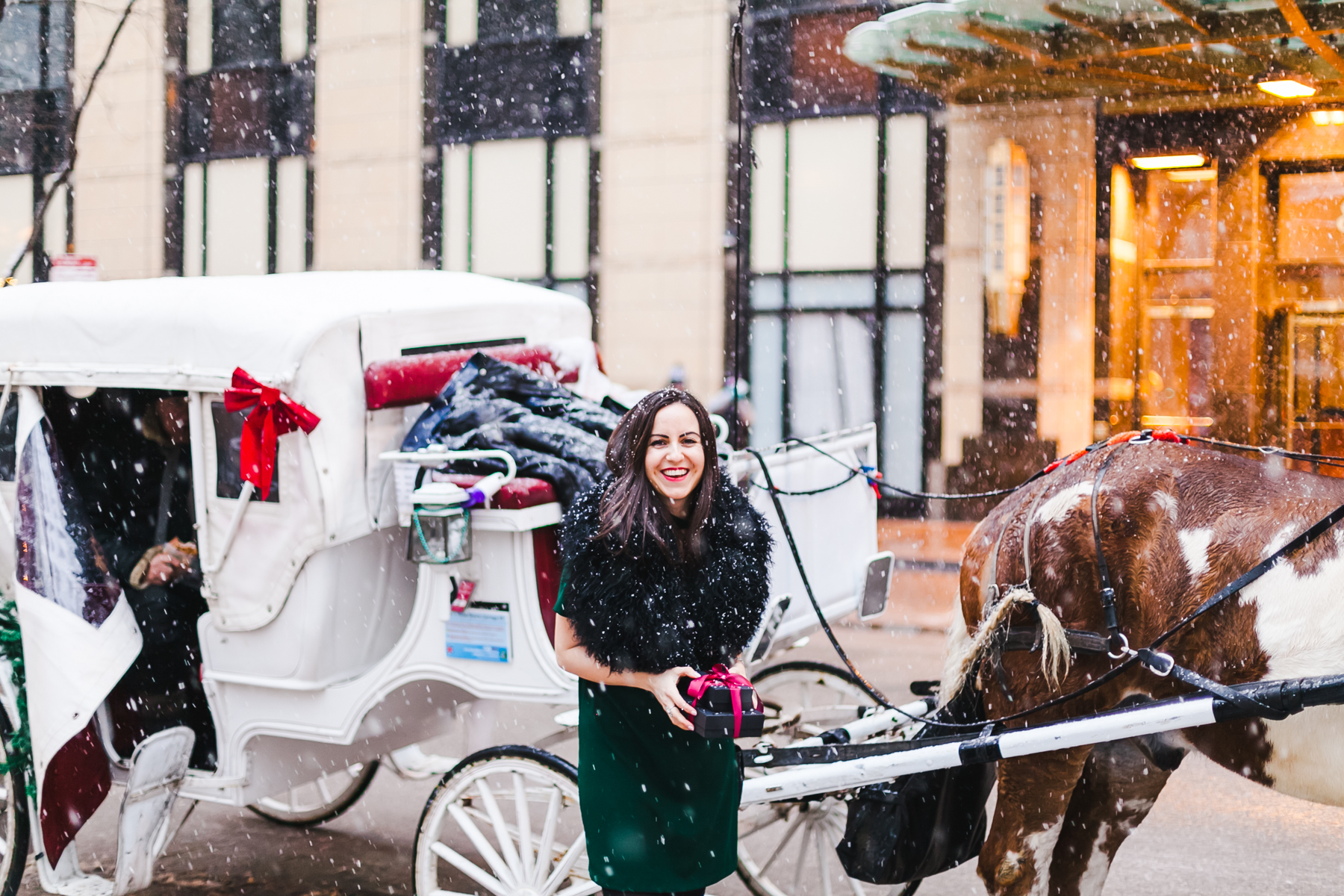 Yana Frigelis of NoMad Luxuries wears a green cocktail dress from zara and a fur scarf from asos for the holidays 