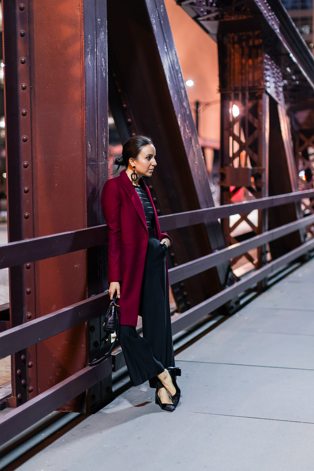 Yana Frigelis of NoMad Luxuries wearing an evening look with a mesh body suit from mango and a red coat from Zara