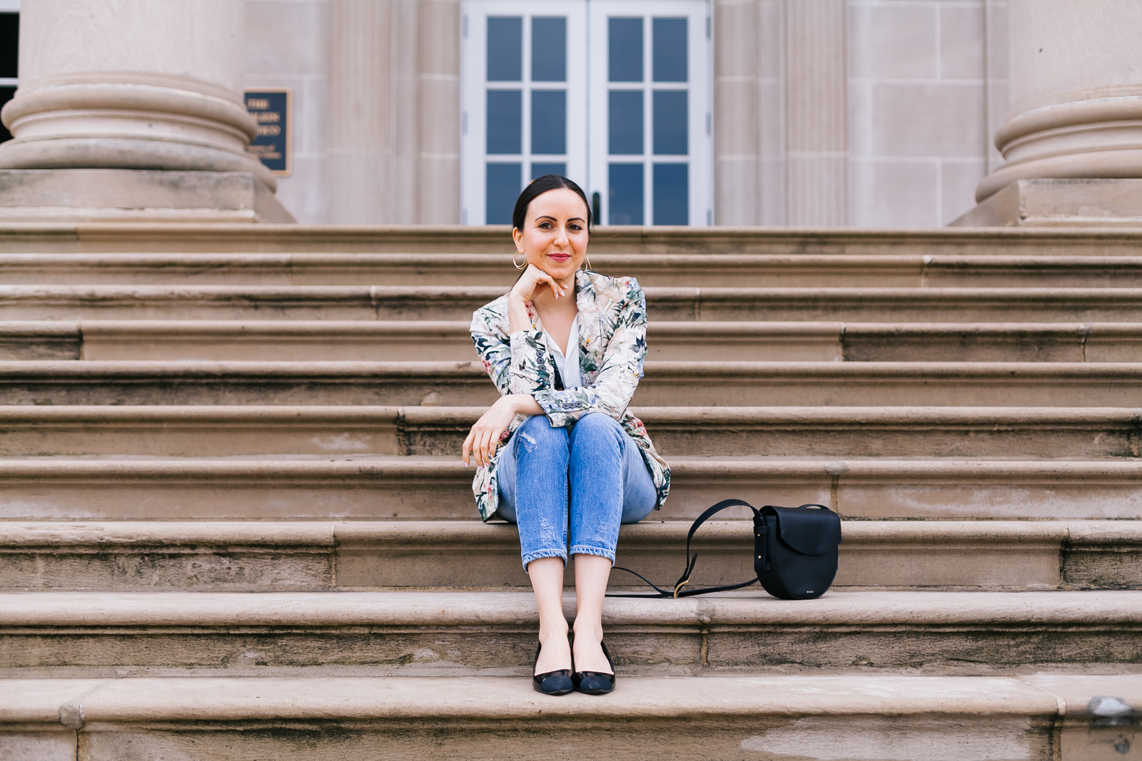 Yana Frigelis of NoMad Luxuries wearing a floral blazer from Zara with boyfriends jeans and black accessories for Spring 