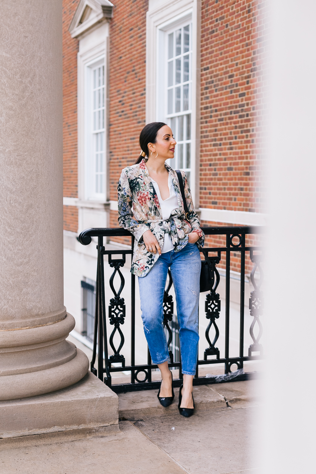 Yana Frigelis of NoMad Luxuries wearing a floral blazer from Zara with boyfriends jeans and black accessories for Spring 