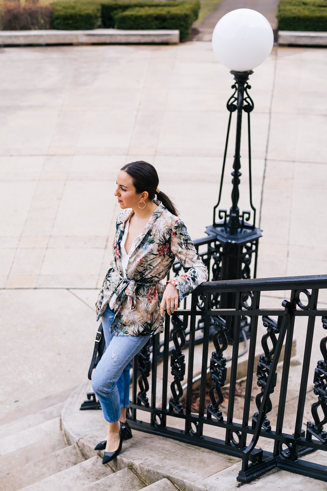 Yana Frigelis of NoMad Luxuries wearing a floral blazer from Zara with boyfriends jeans and black accessories for Spring 