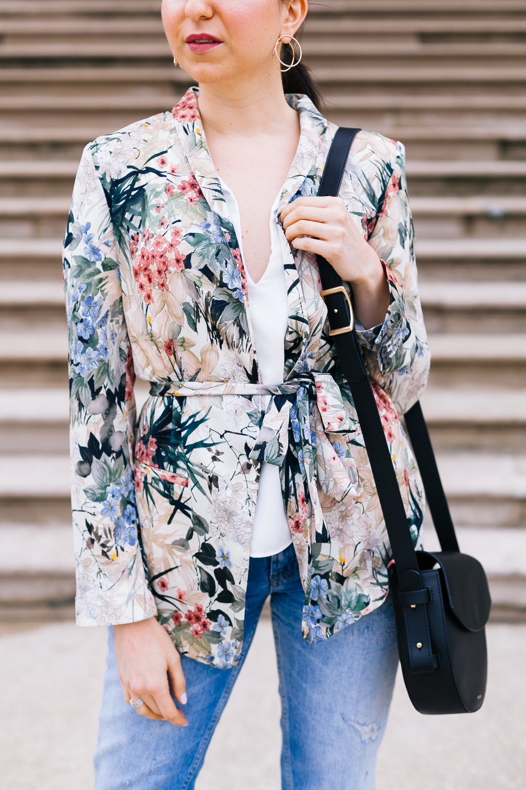 Yana Frigelis of NoMad Luxuries wearing a floral blazer from Zara with boyfriends jeans and black accessories for Spring 