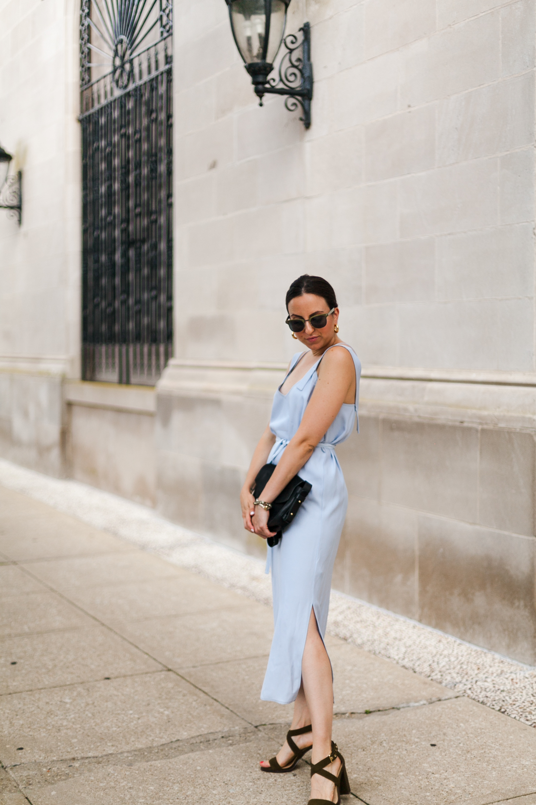 Yana Frigelis of NoMad Luxuries wearing a powder blue topshop dress and olive green suede sandals to an end of summer wedding 