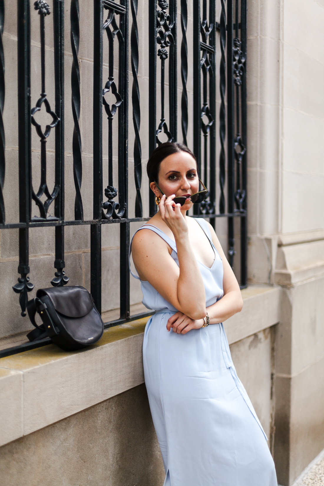 Yana Frigelis of NoMad Luxuries wearing a powder blue topshop dress and olive green suede sandals to an end of summer wedding 