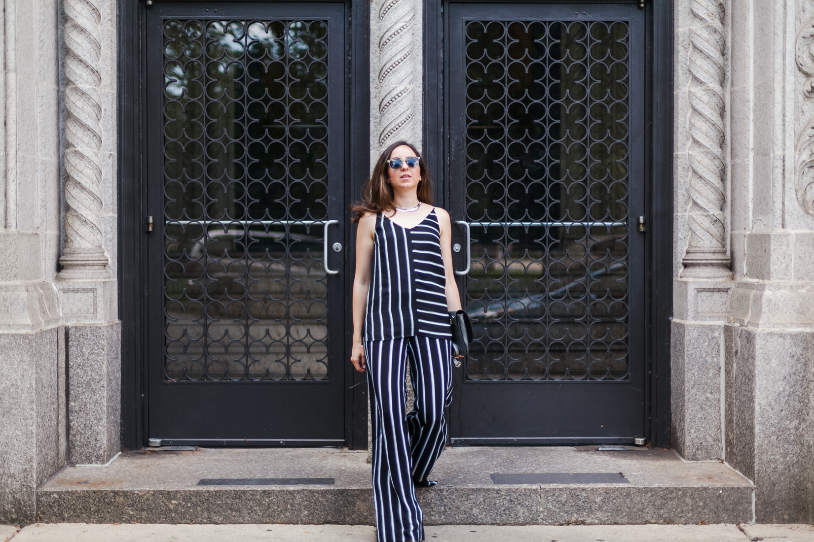 Yana Frigelis of NoMad Luxuries wearing a striped coord set transitioning into fall wardrobe 