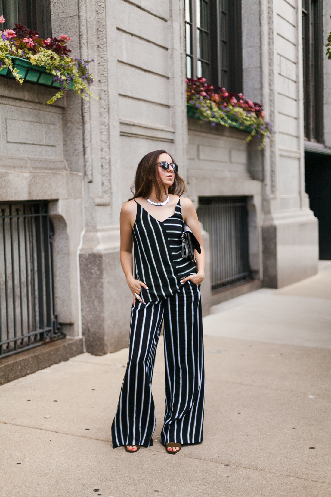 Yana Frigelis of NoMad Luxuries wearing a striped coord set transitioning into fall wardrobe 