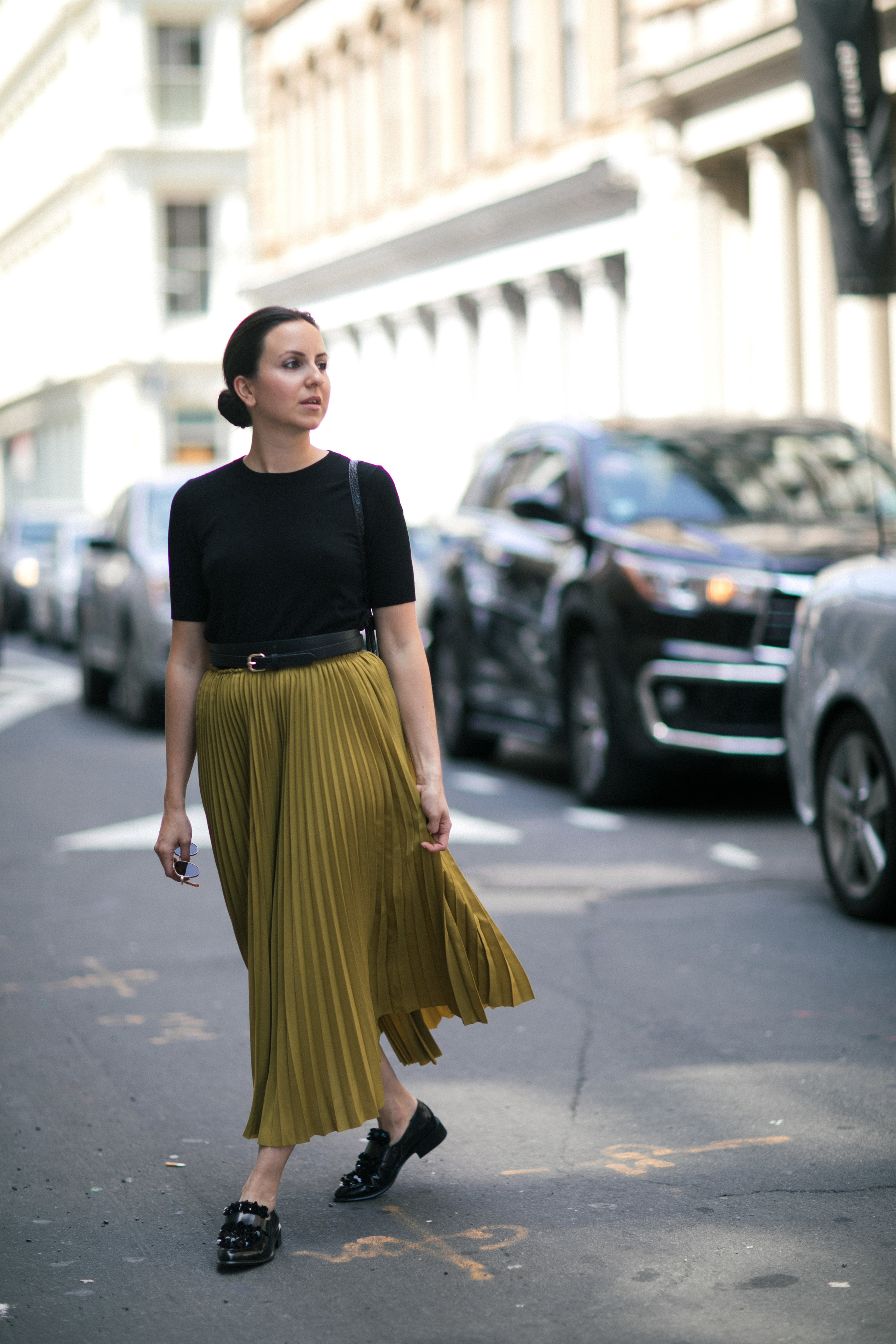 Yana Frigelis of NoMad Luxuries wearing a midi skirt from Zara for a fall trend and loafers for a casual look in new york