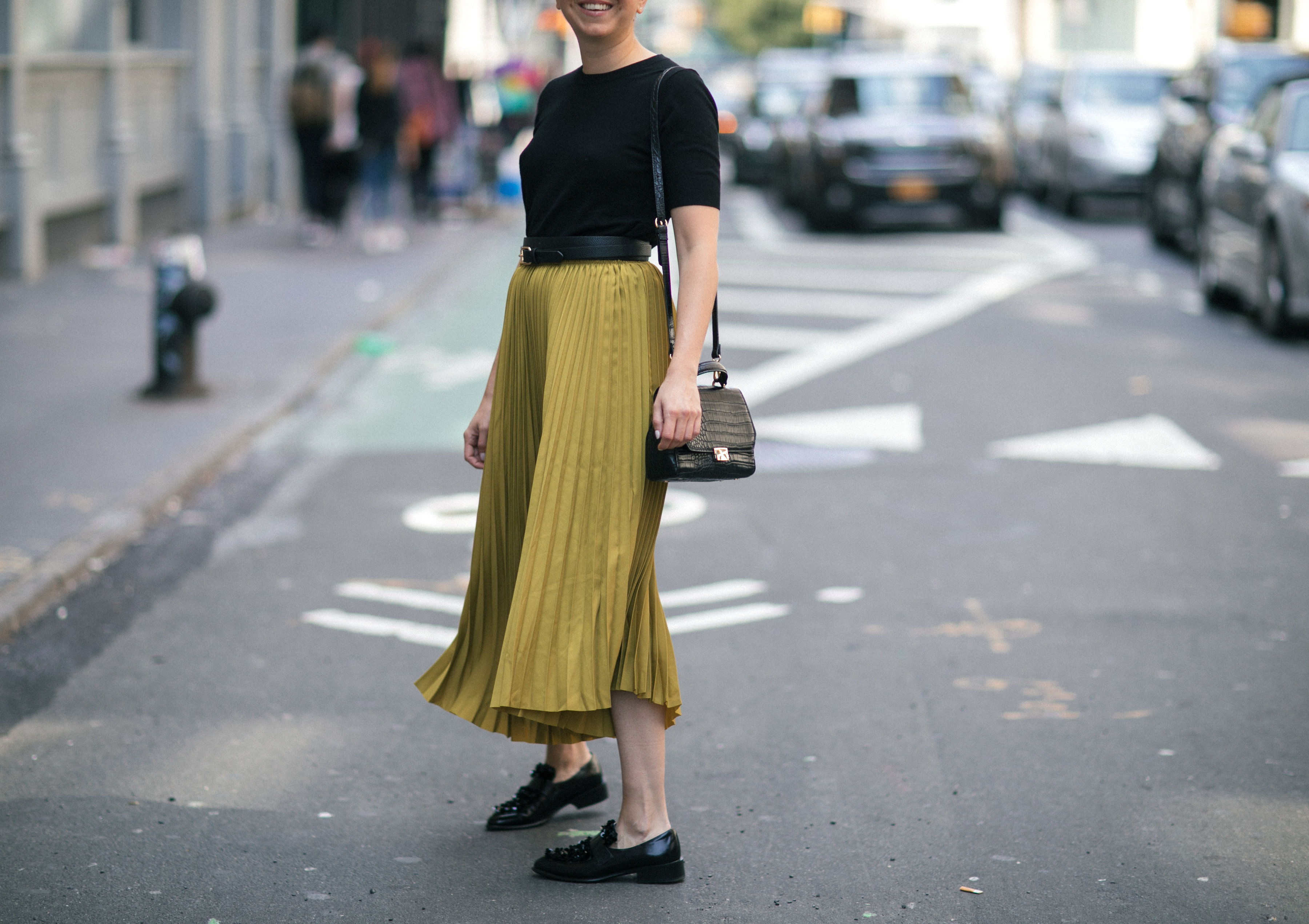 Yana Frigelis of NoMad Luxuries wearing a midi skirt from Zara for a fall trend and loafers for a casual look in new york