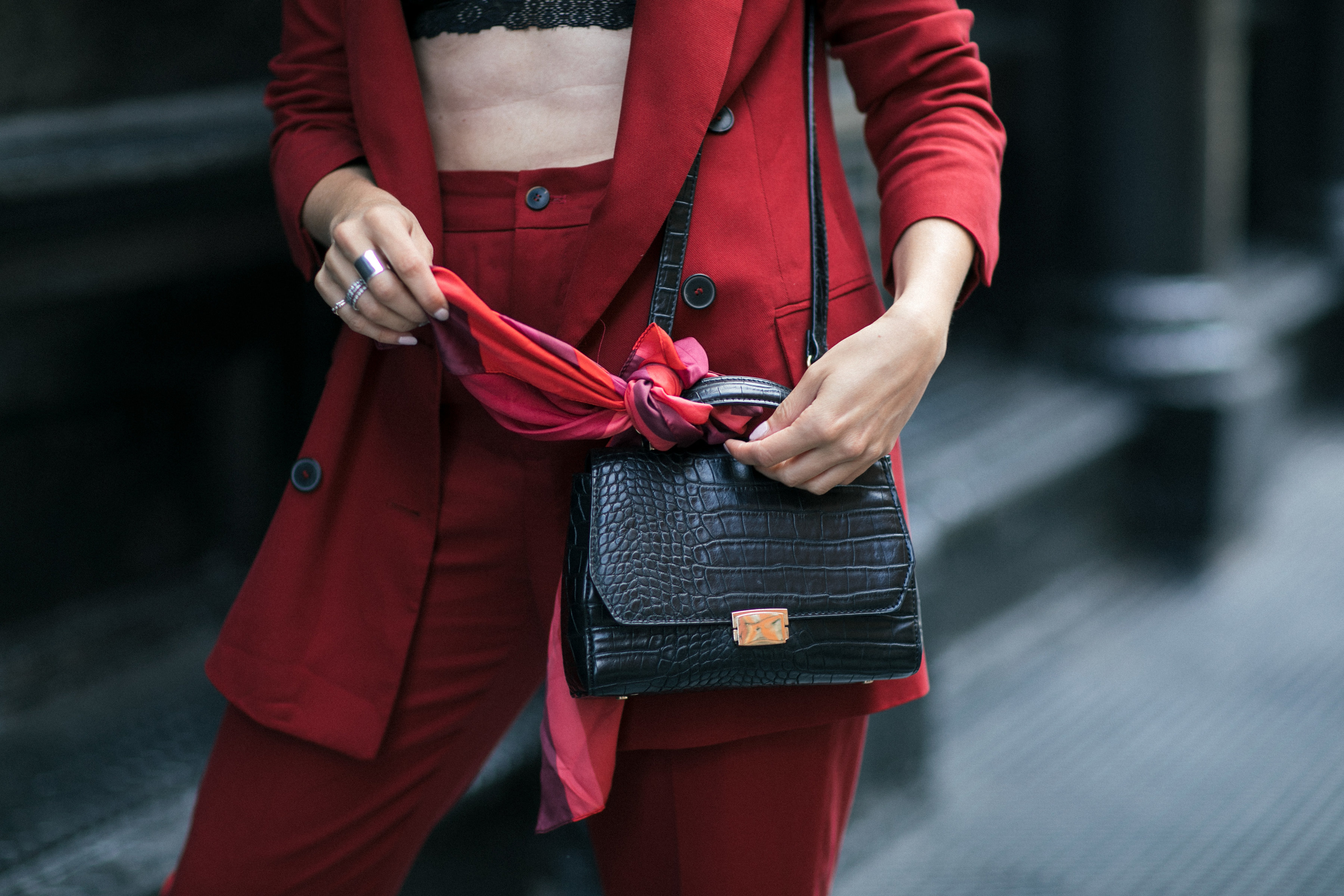 Yana Frigelis of NoMad Luxuries wearing Fall's it color of the season red for new york fashion week in a pant suit from Zara