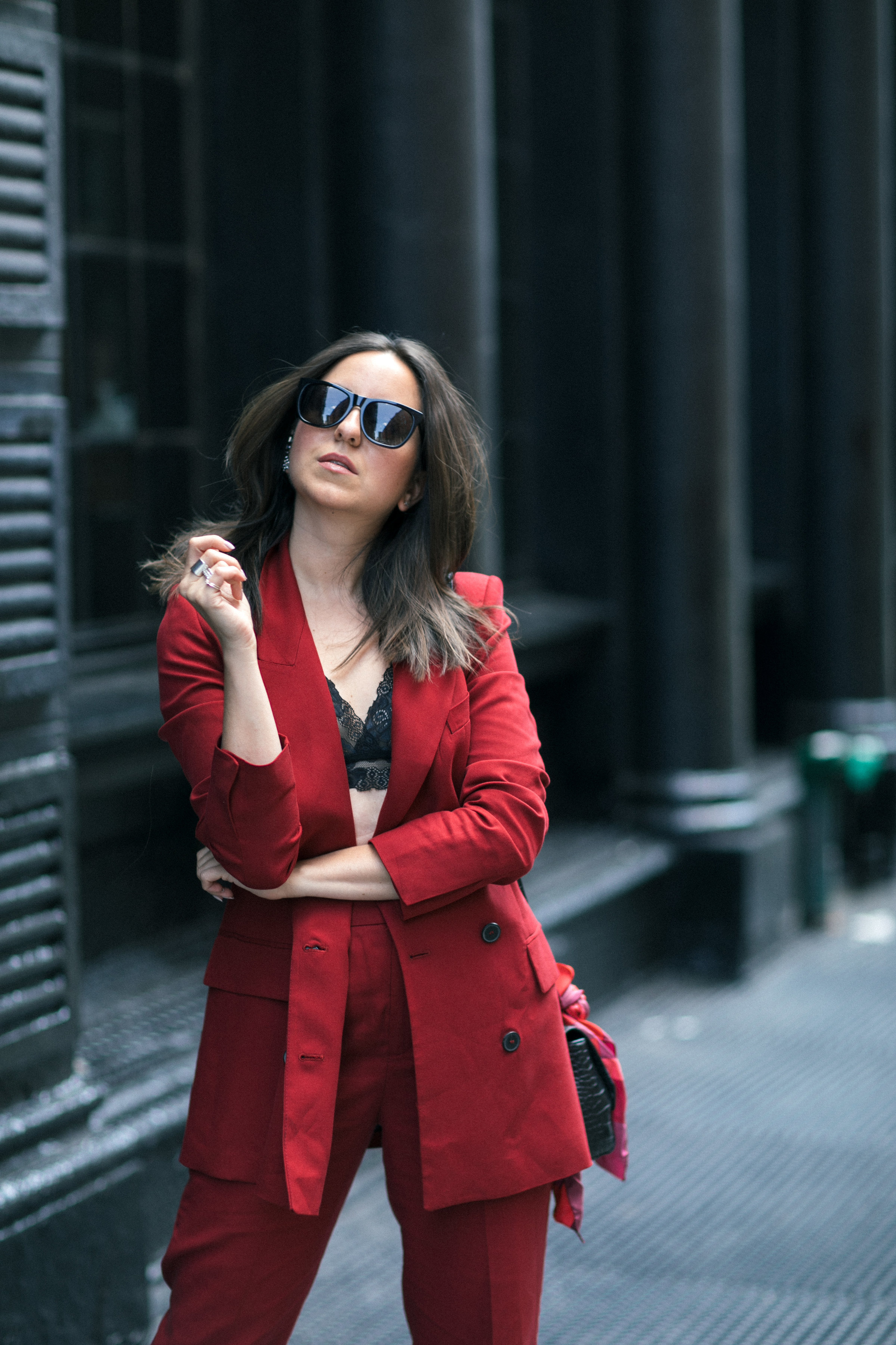 Yana Frigelis of NoMad Luxuries wearing Fall's it color of the season red for new york fashion week in a pant suit from Zara