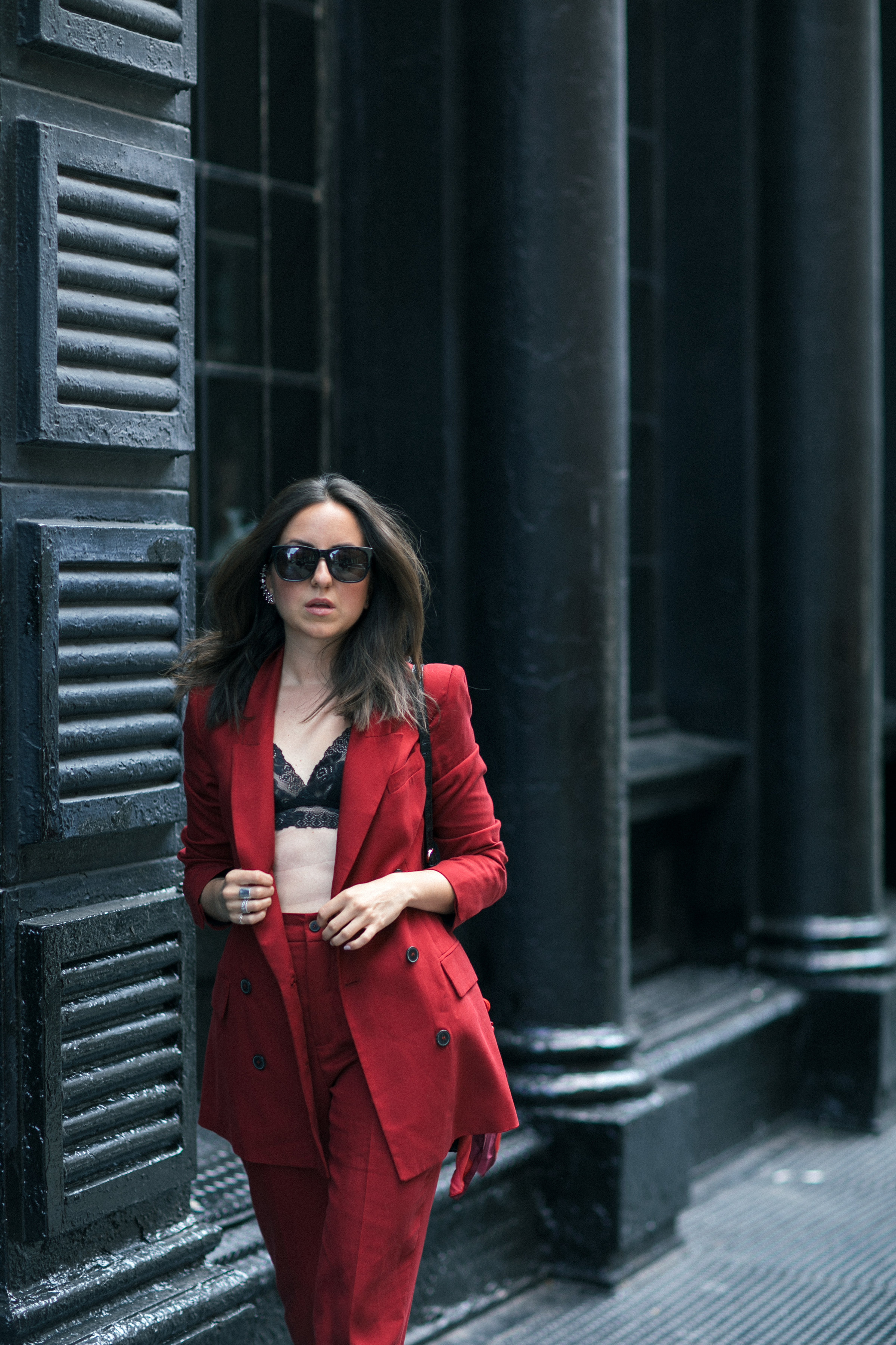 Yana Frigelis of NoMad Luxuries wearing Fall's it color of the season red for new york fashion week in a pant suit from Zara