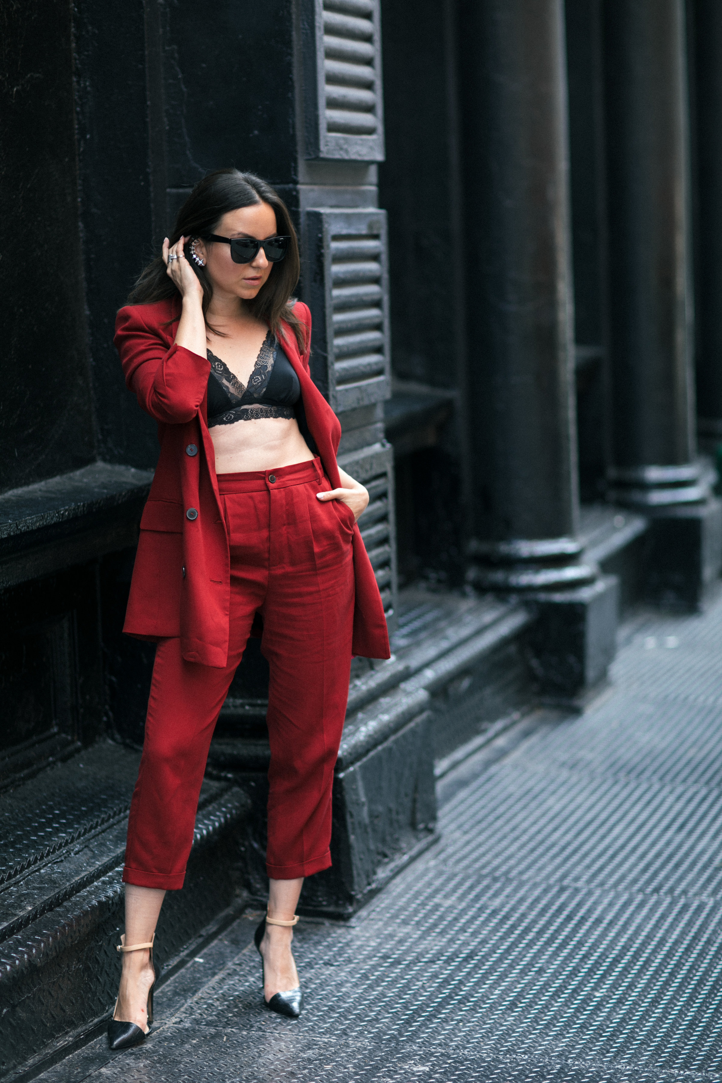 Yana Frigelis of NoMad Luxuries wearing Fall's it color of the season red for new york fashion week in a pant suit from Zara