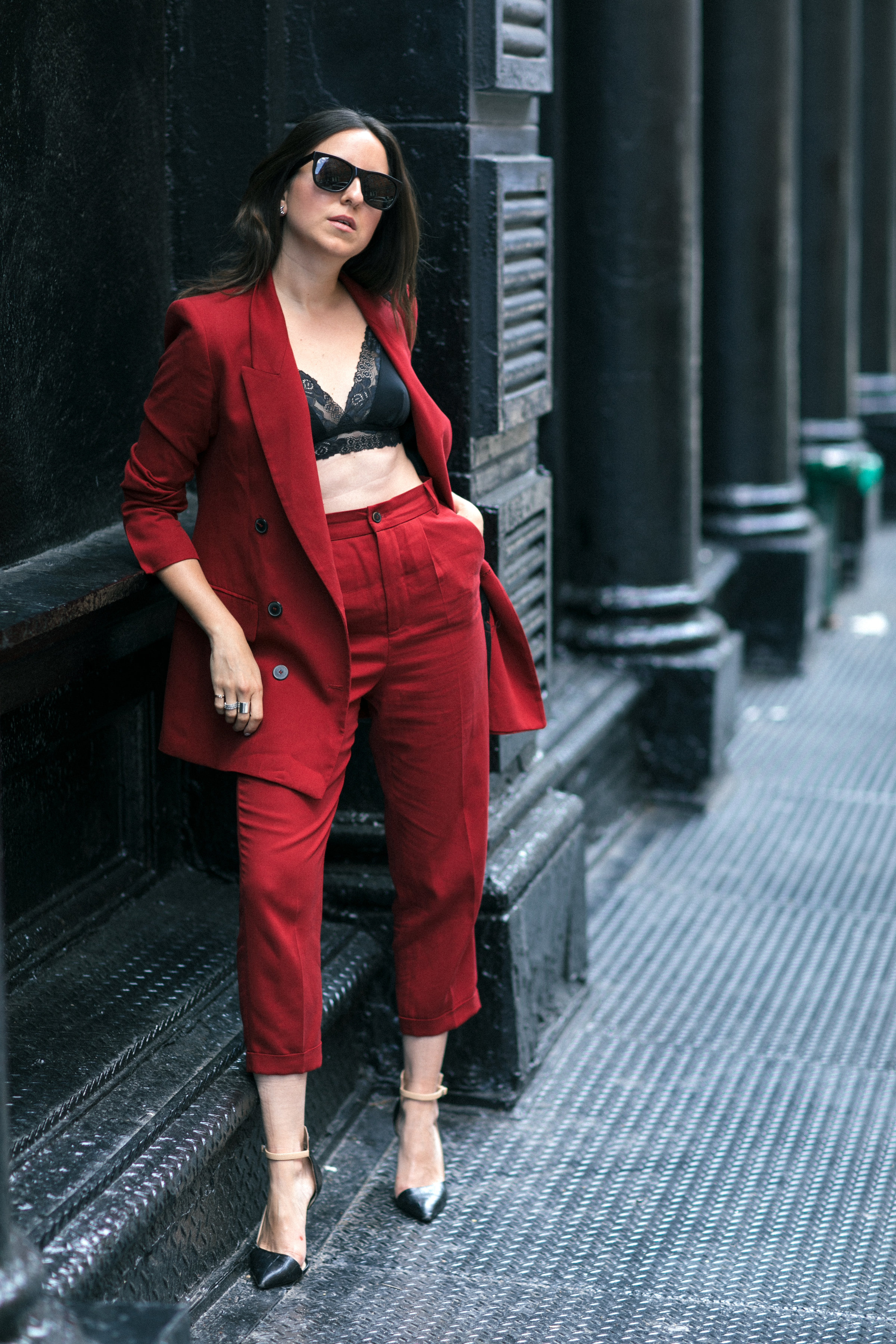 Yana Frigelis of NoMad Luxuries wearing Fall's it color of the season red for new york fashion week in a pant suit from Zara