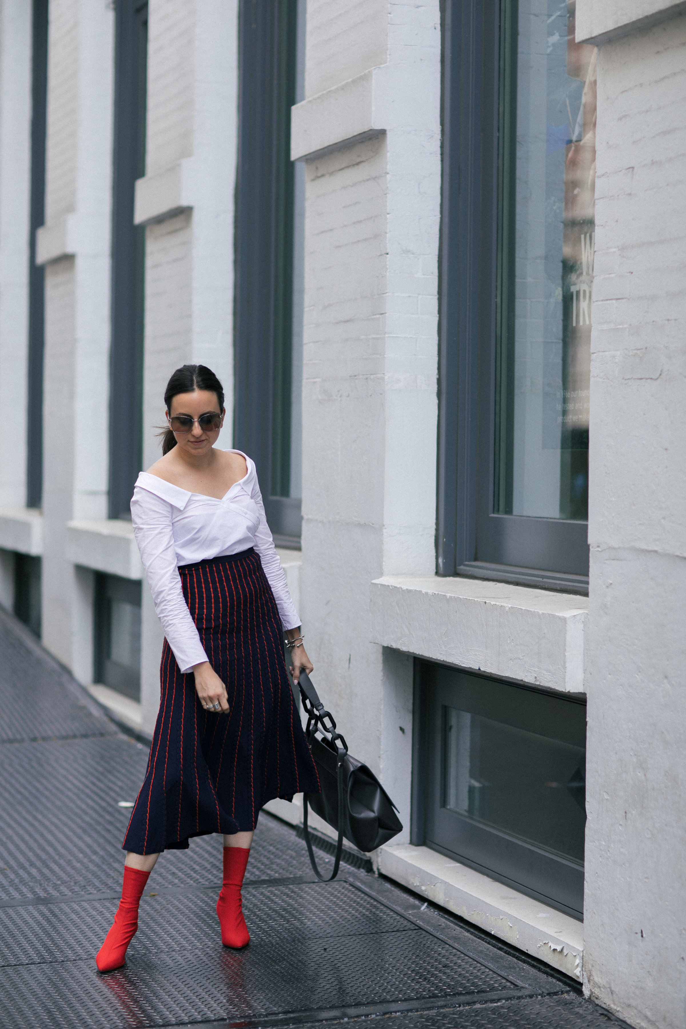 Yana Frigelis of NoMad Luxuries wearing a knit midi skirt and red boots for an fresh take on work-wear in Chicago for the Fall 