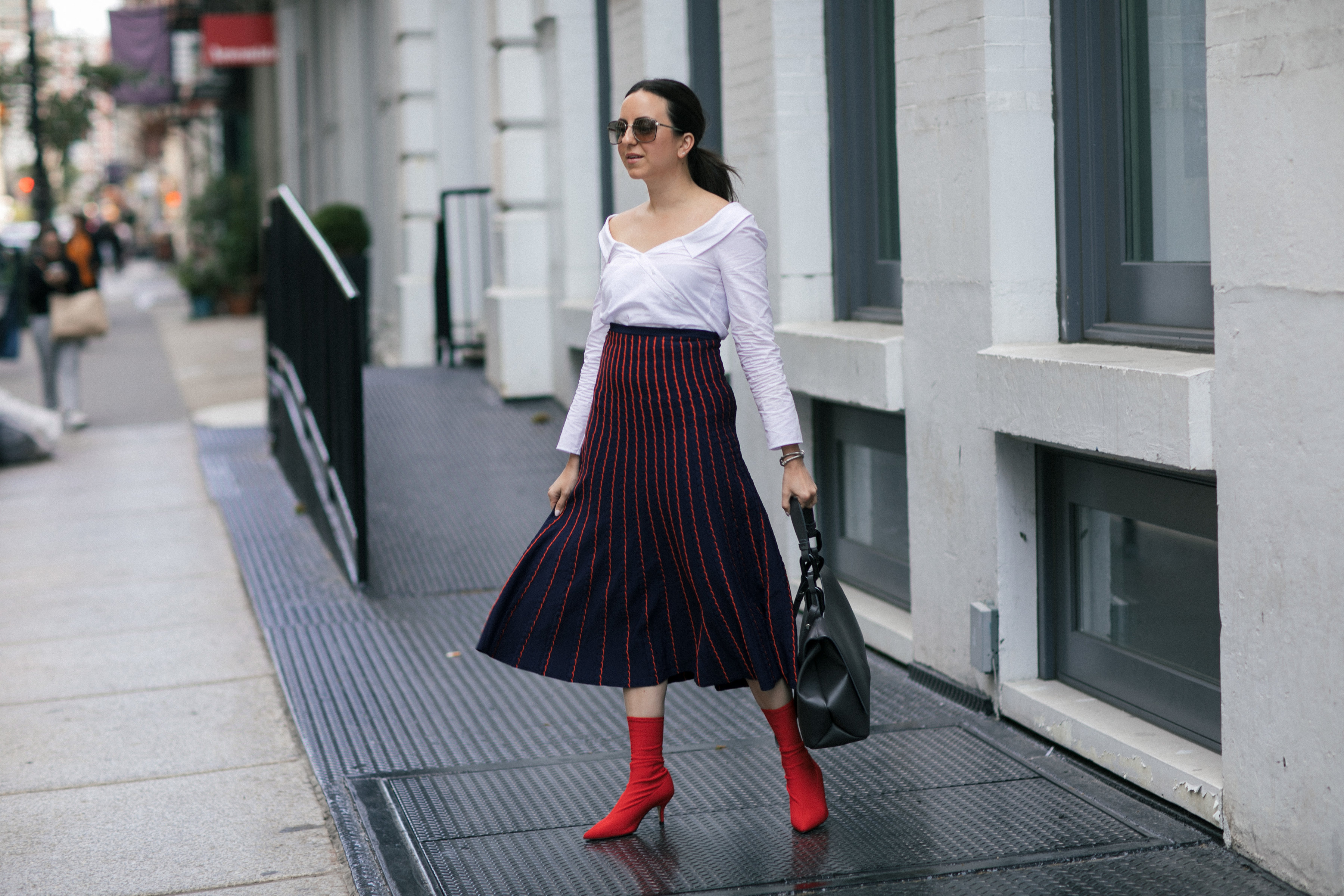 Yana Frigelis of NoMad Luxuries wearing a knit midi skirt and red boots for an fresh take on work-wear in Chicago for the Fall 