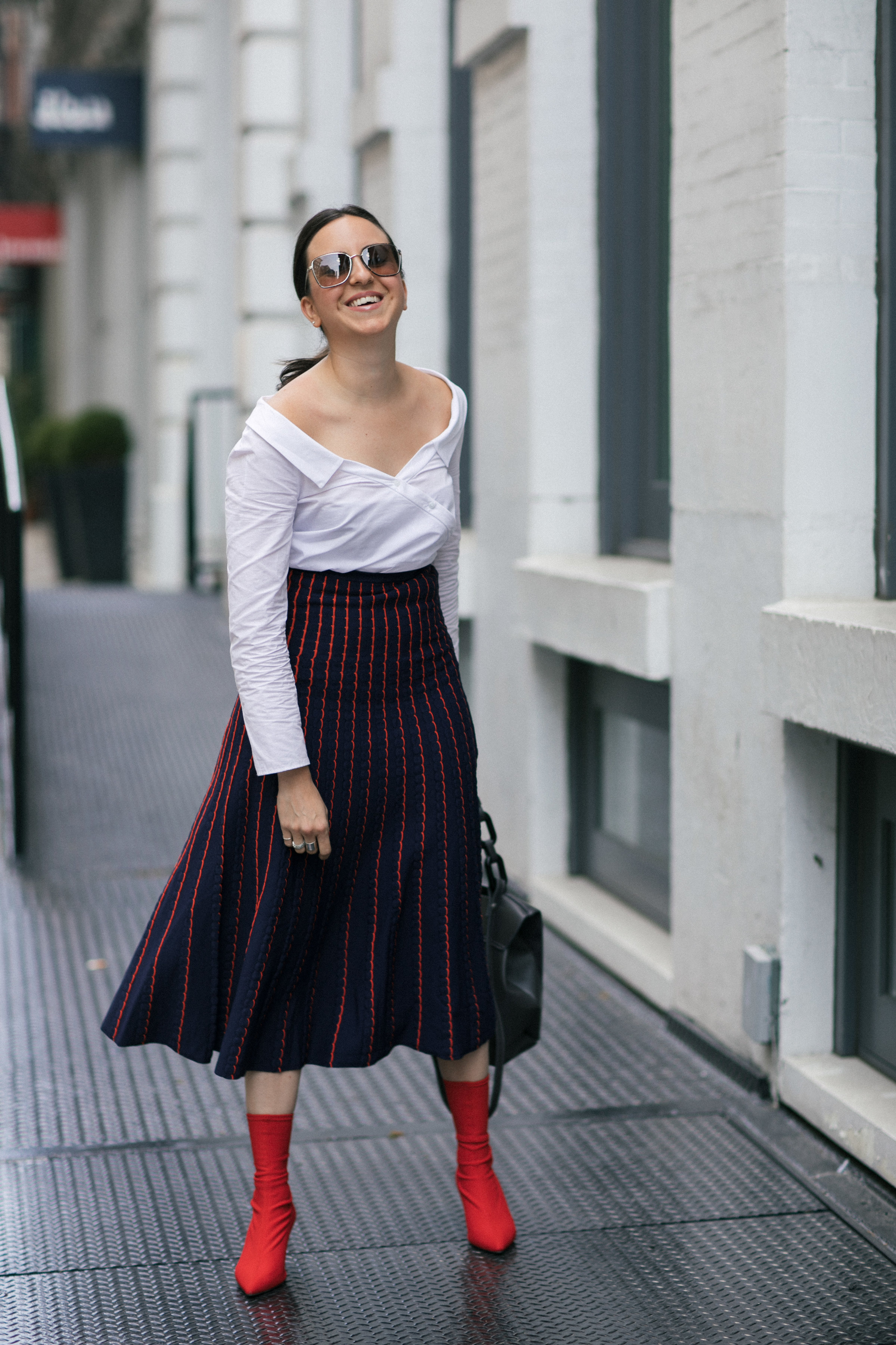 Yana Frigelis of NoMad Luxuries wearing a knit midi skirt and red boots for an fresh take on work-wear in Chicago for the Fall 