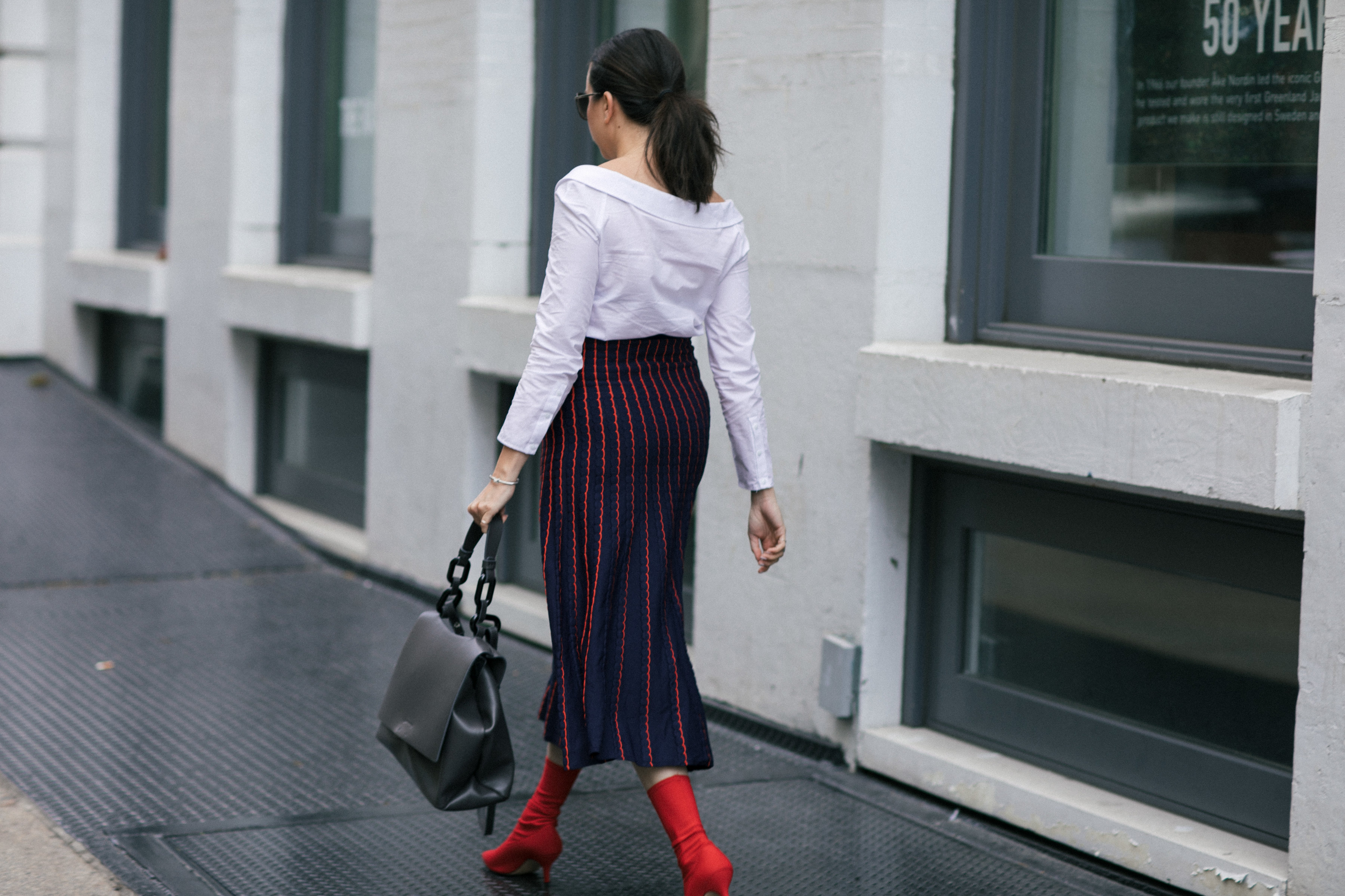 Yana Frigelis of NoMad Luxuries wearing a knit midi skirt and red boots for an fresh take on work-wear in Chicago for the Fall 