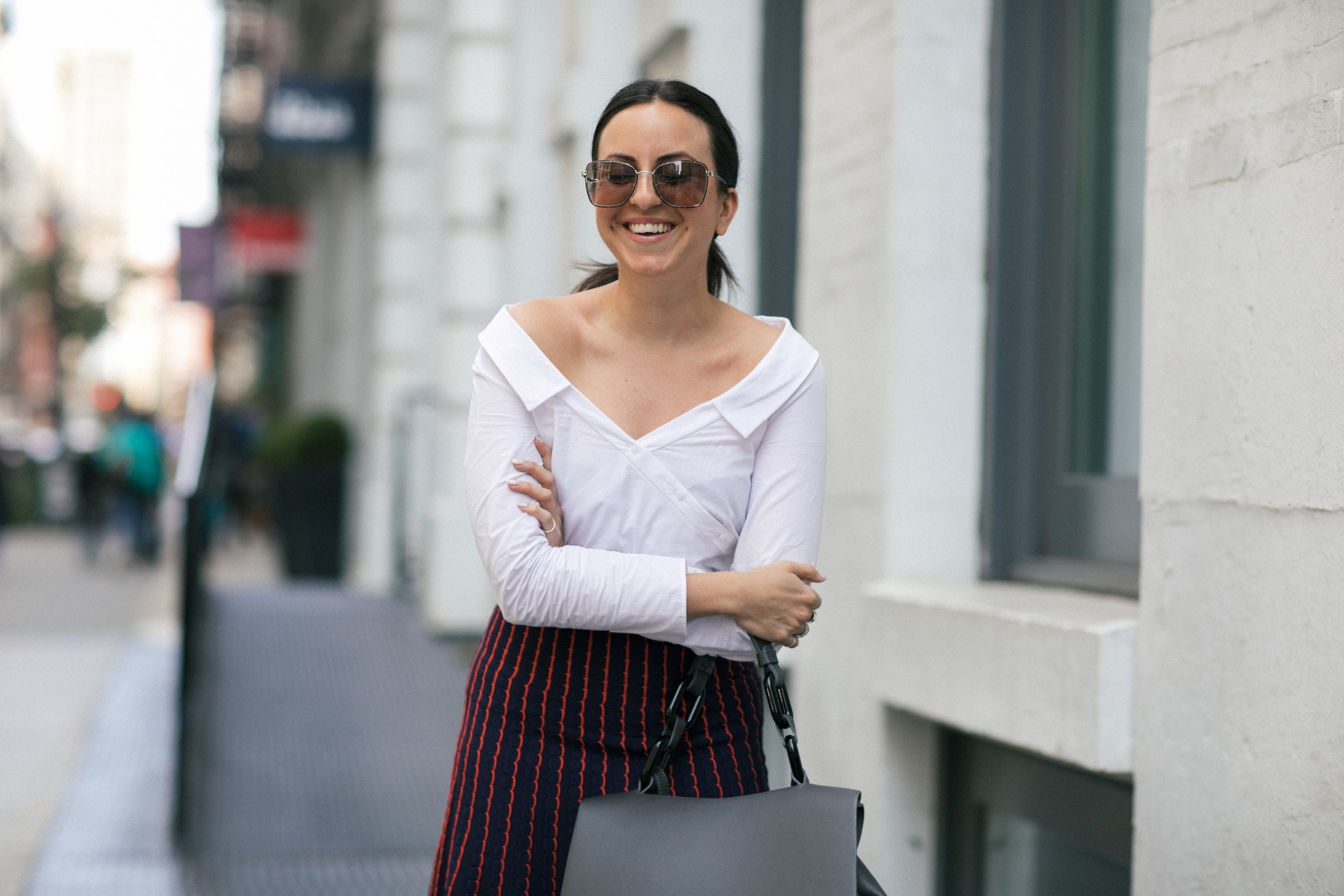 Yana Frigelis of NoMad Luxuries wearing a knit midi skirt and red boots for an fresh take on work-wear in Chicago for the Fall 