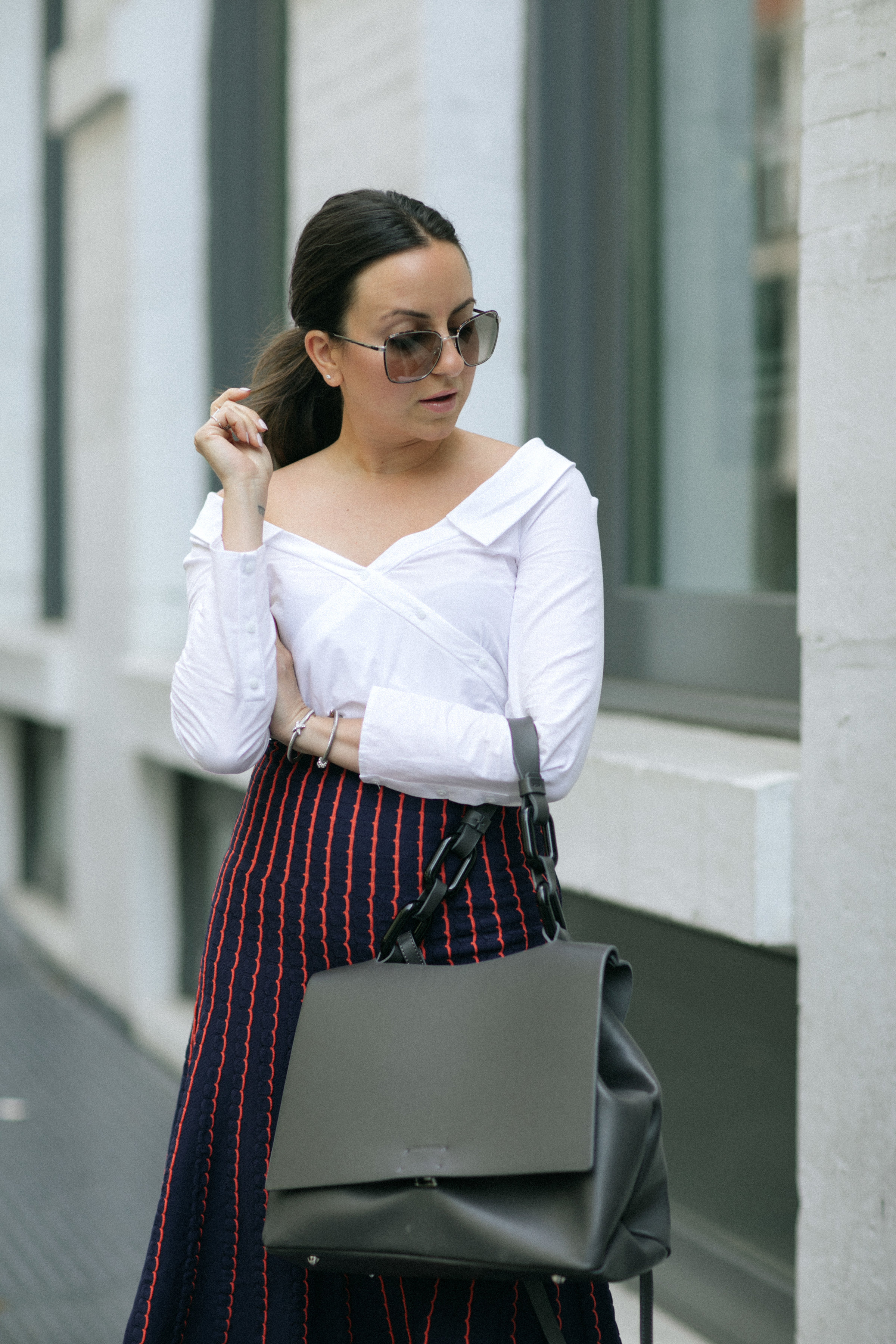 Yana Frigelis of NoMad Luxuries wearing a knit midi skirt and red boots for an fresh take on work-wear in Chicago for the Fall 