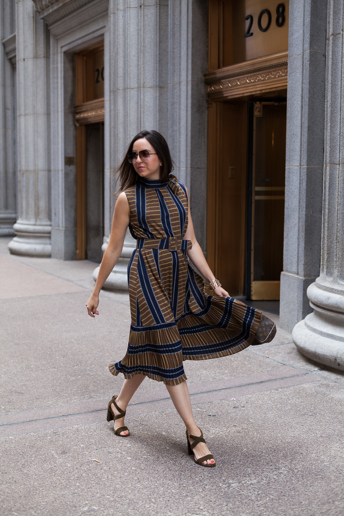 Yana Frigelis of NoMad Luxuries wearing a ladylike, retro inspired ruffled dress for Fall from Gracia 