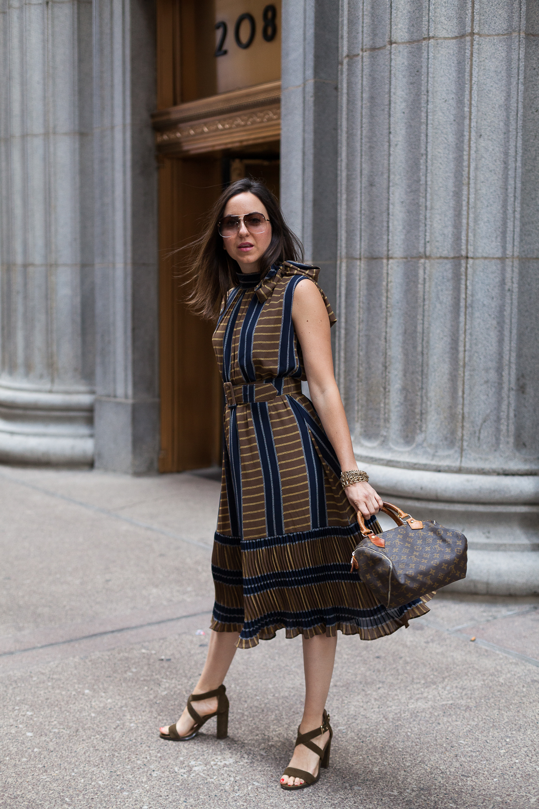 Yana Frigelis of NoMad Luxuries wearing a ladylike, retro inspired ruffled dress for Fall from Gracia 