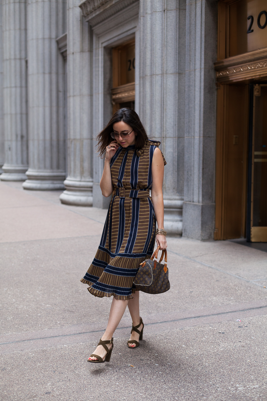 Yana Frigelis of NoMad Luxuries wearing a ladylike, retro inspired ruffled dress for Fall from Gracia 