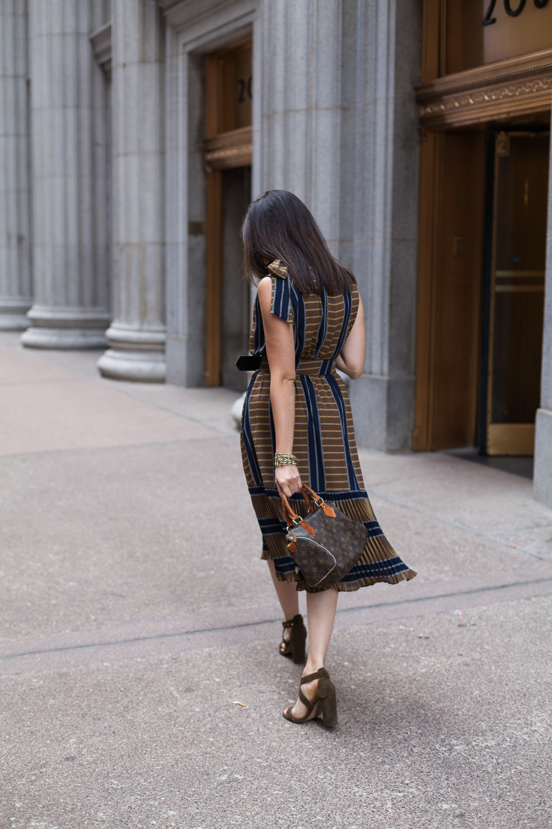 Yana Frigelis of NoMad Luxuries wearing a ladylike, retro inspired ruffled dress for Fall from Gracia 