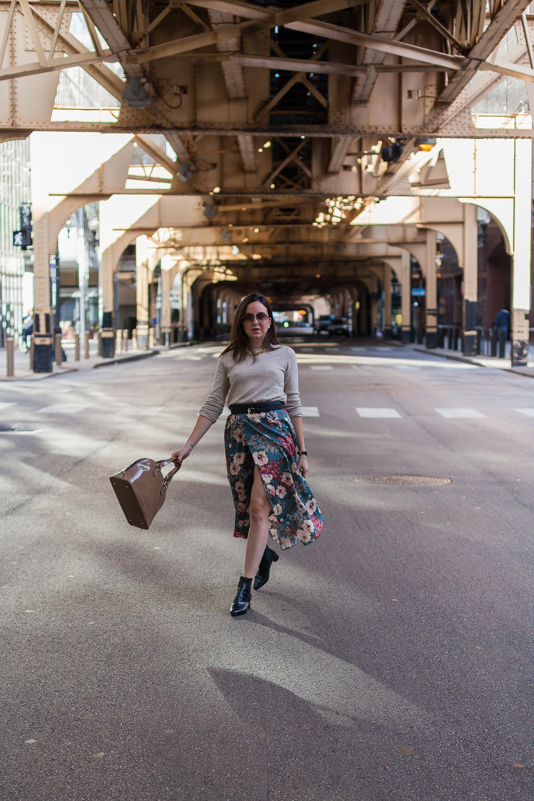 Yana Frigelis of NoMad Luxuries wearing a floral midi skirt with a neutral sweater for a Thanksgiving get together 