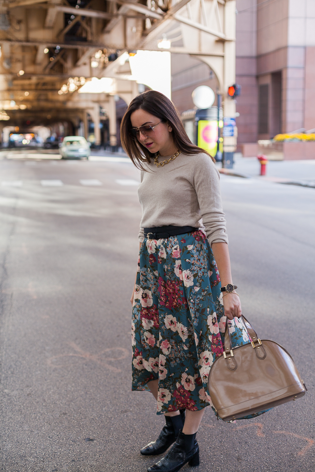 Yana Frigelis of NoMad Luxuries wearing a floral midi skirt with a neutral sweater for a Thanksgiving get together 