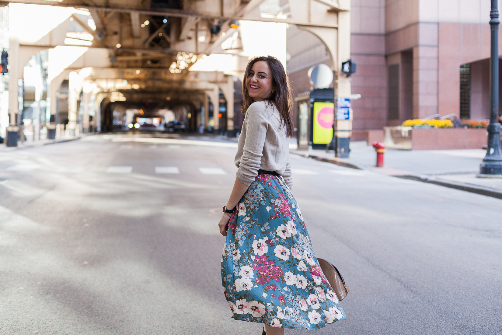 Yana Frigelis of NoMad Luxuries wearing a floral midi skirt with a neutral sweater for a Thanksgiving get together 