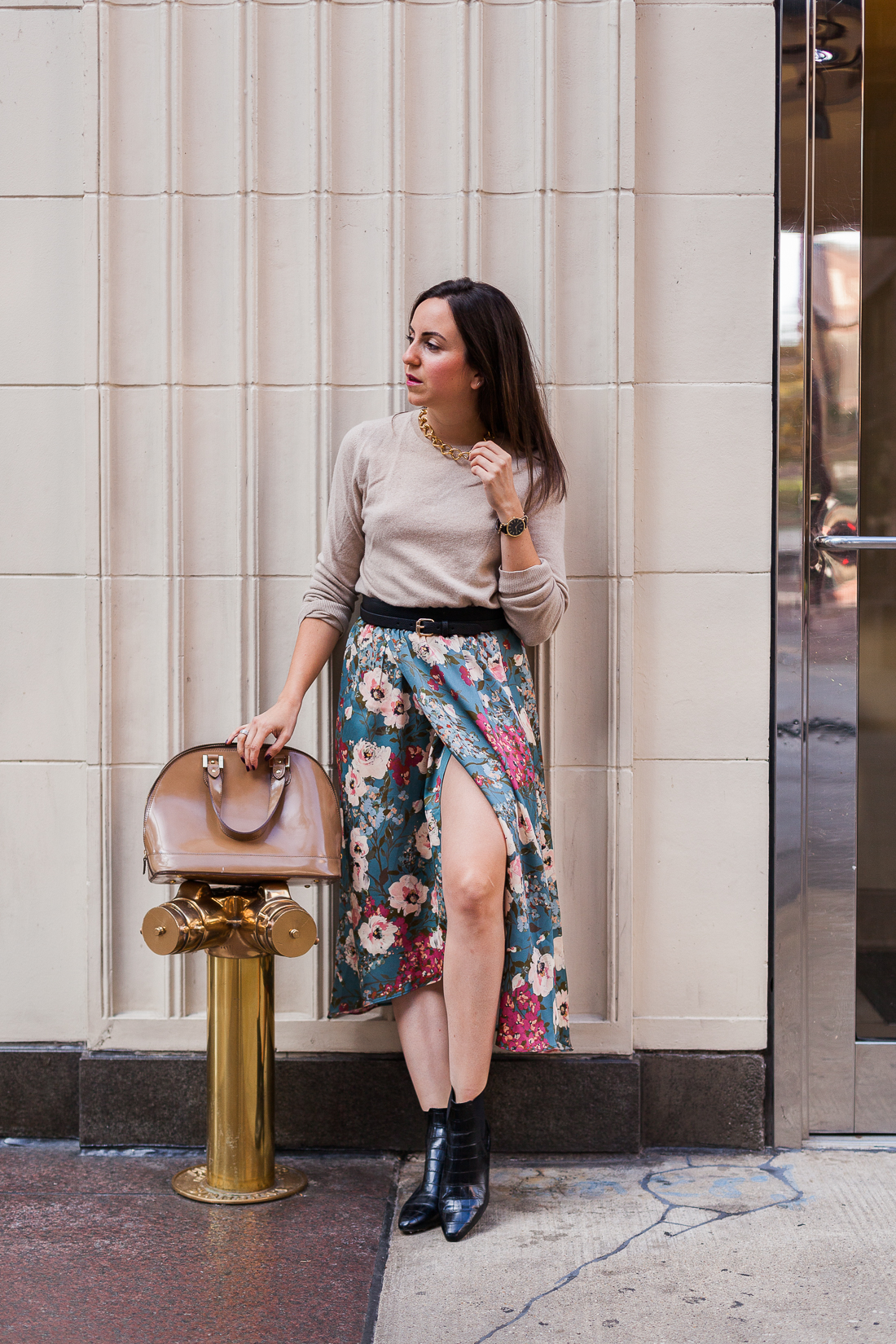 Yana Frigelis of NoMad Luxuries wearing a floral midi skirt with a neutral sweater for a Thanksgiving get together 