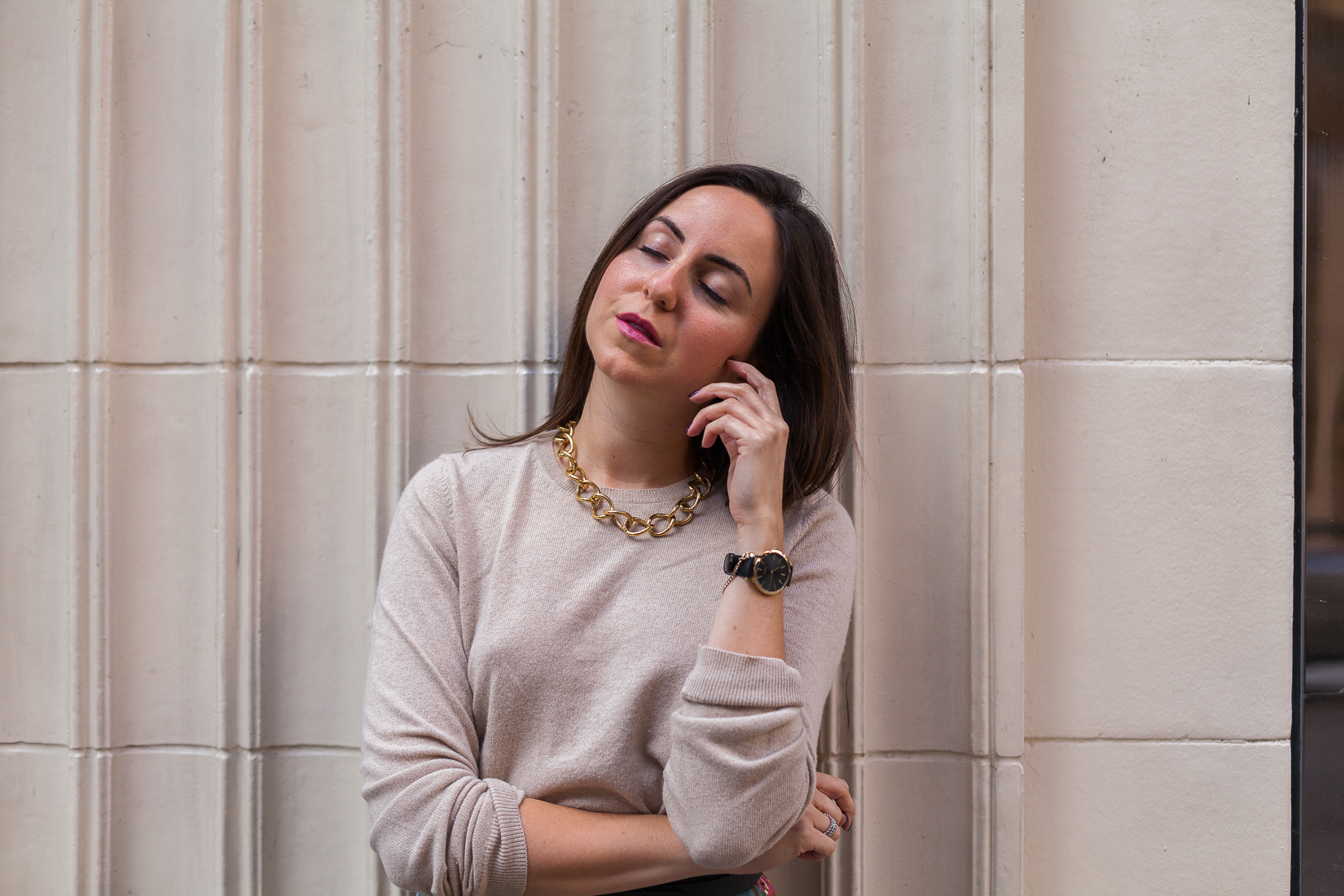 Yana Frigelis of NoMad Luxuries wearing a floral midi skirt with a neutral sweater for a Thanksgiving get together 