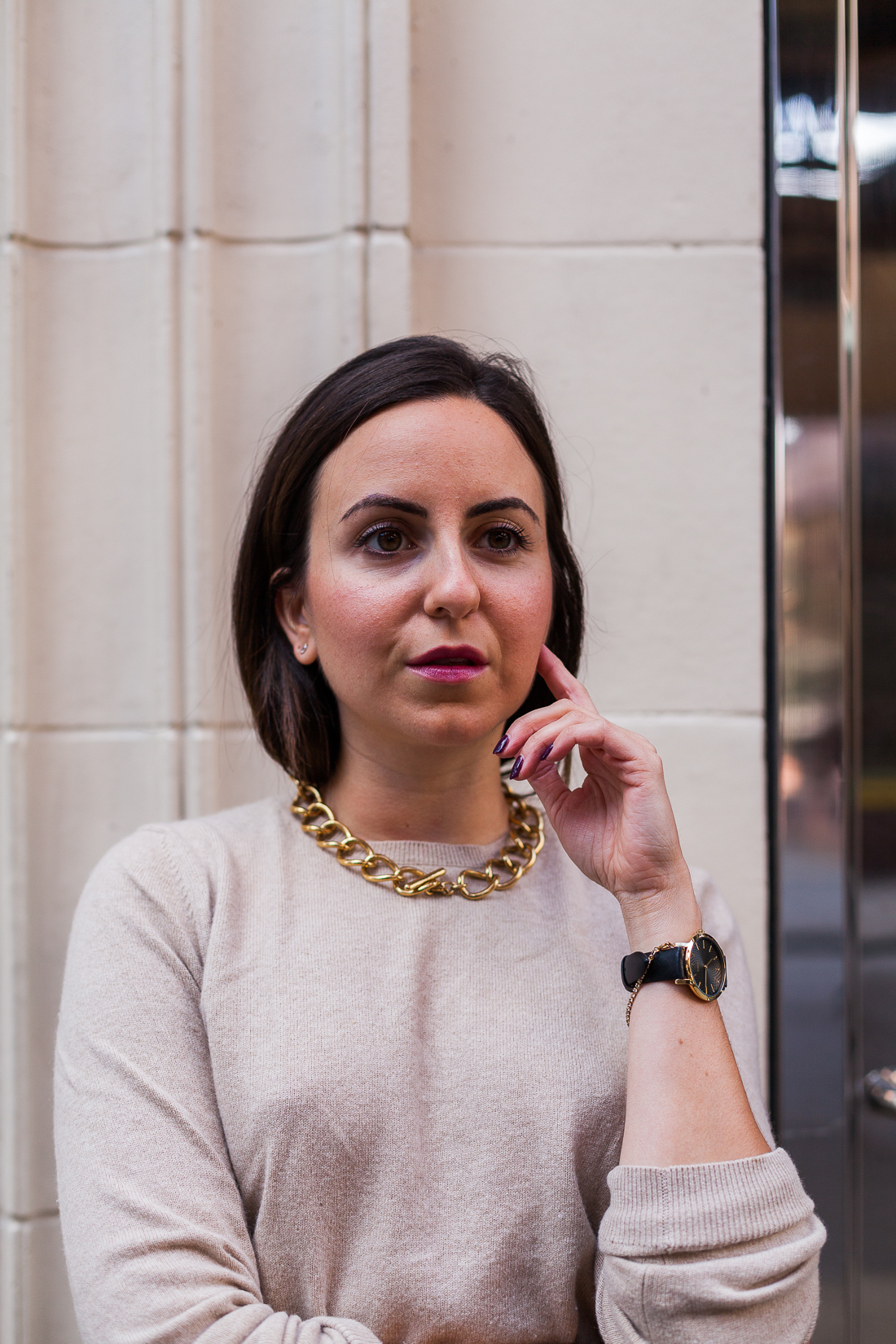 Yana Frigelis of NoMad Luxuries wearing a floral midi skirt with a neutral sweater for a Thanksgiving get together 