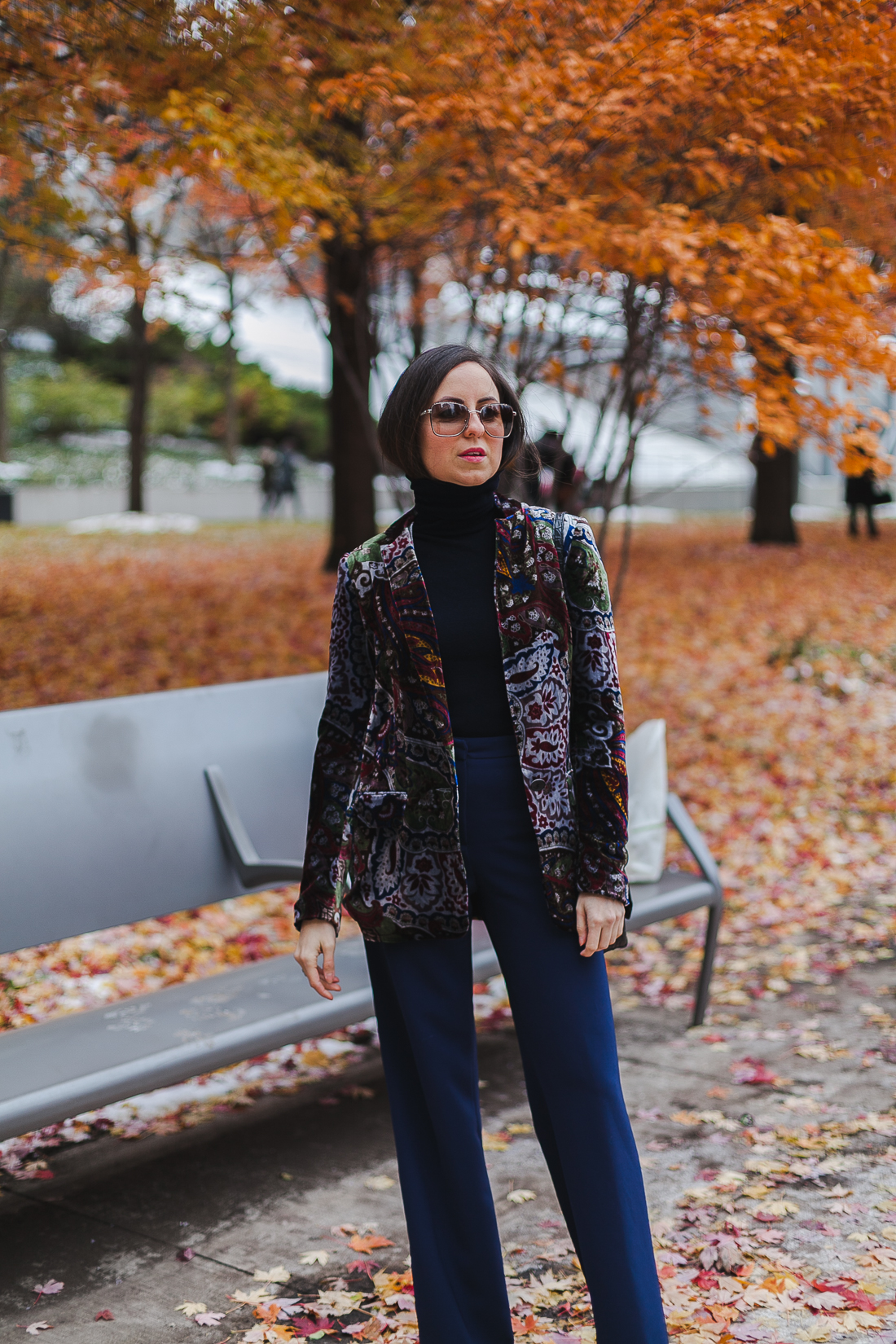 Yana Frigelis of NoMad Luxuries wearinga velvet paisley blazer, high-waisted navy pants for Thanksgiving with a 70's vibe in Chicago