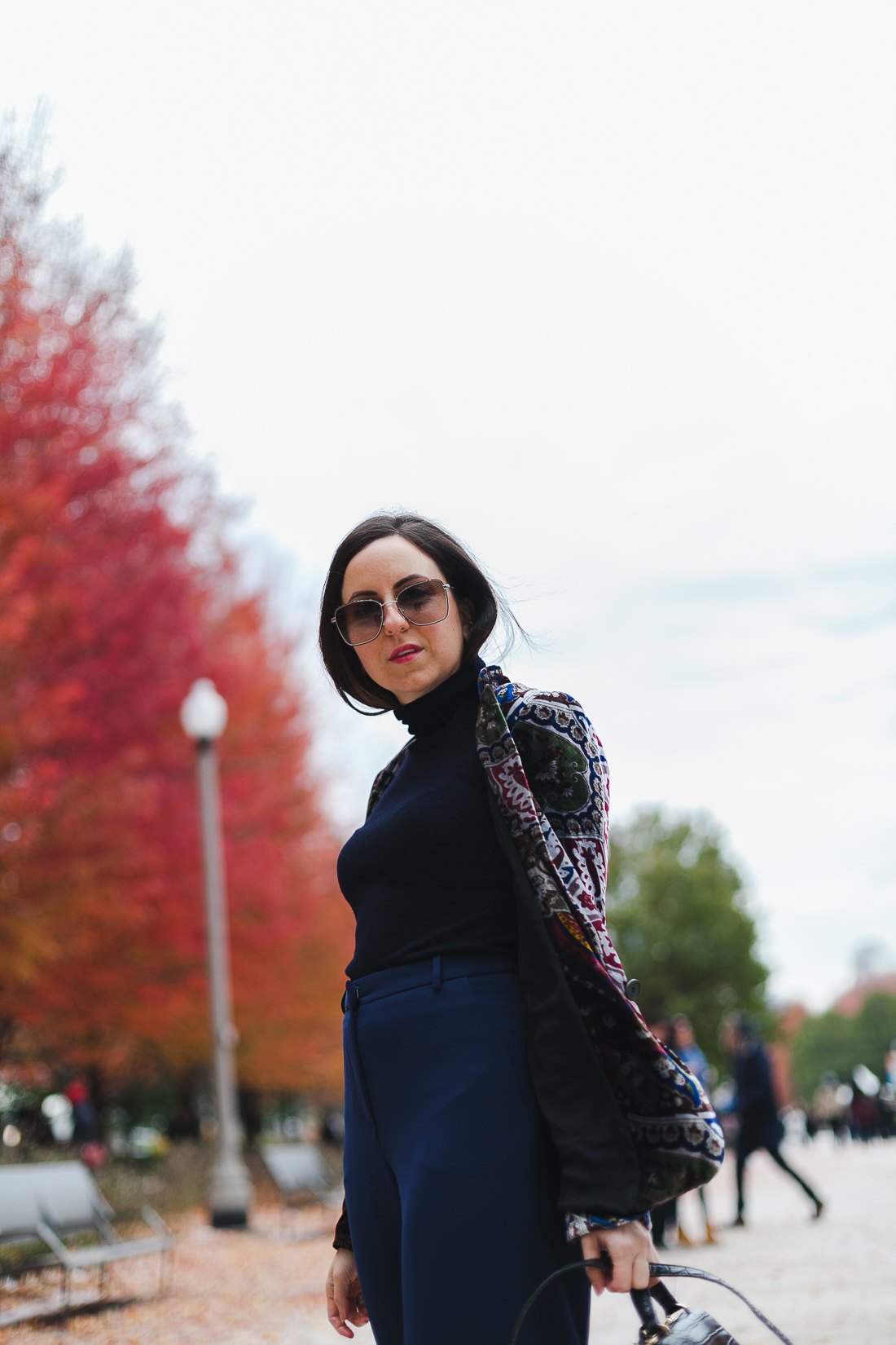 Yana Frigelis of NoMad Luxuries wearinga velvet paisley blazer, high-waisted navy pants for Thanksgiving with a 70's vibe in Chicago