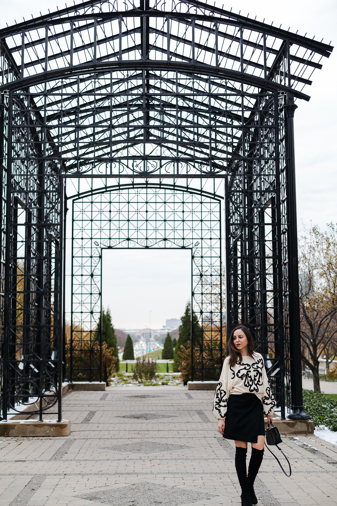 Yana Frigelis of NoMad Luxuries wearing an embroidered sweatshirt from zara and over the knee boots for a simple yet statement making outfit 