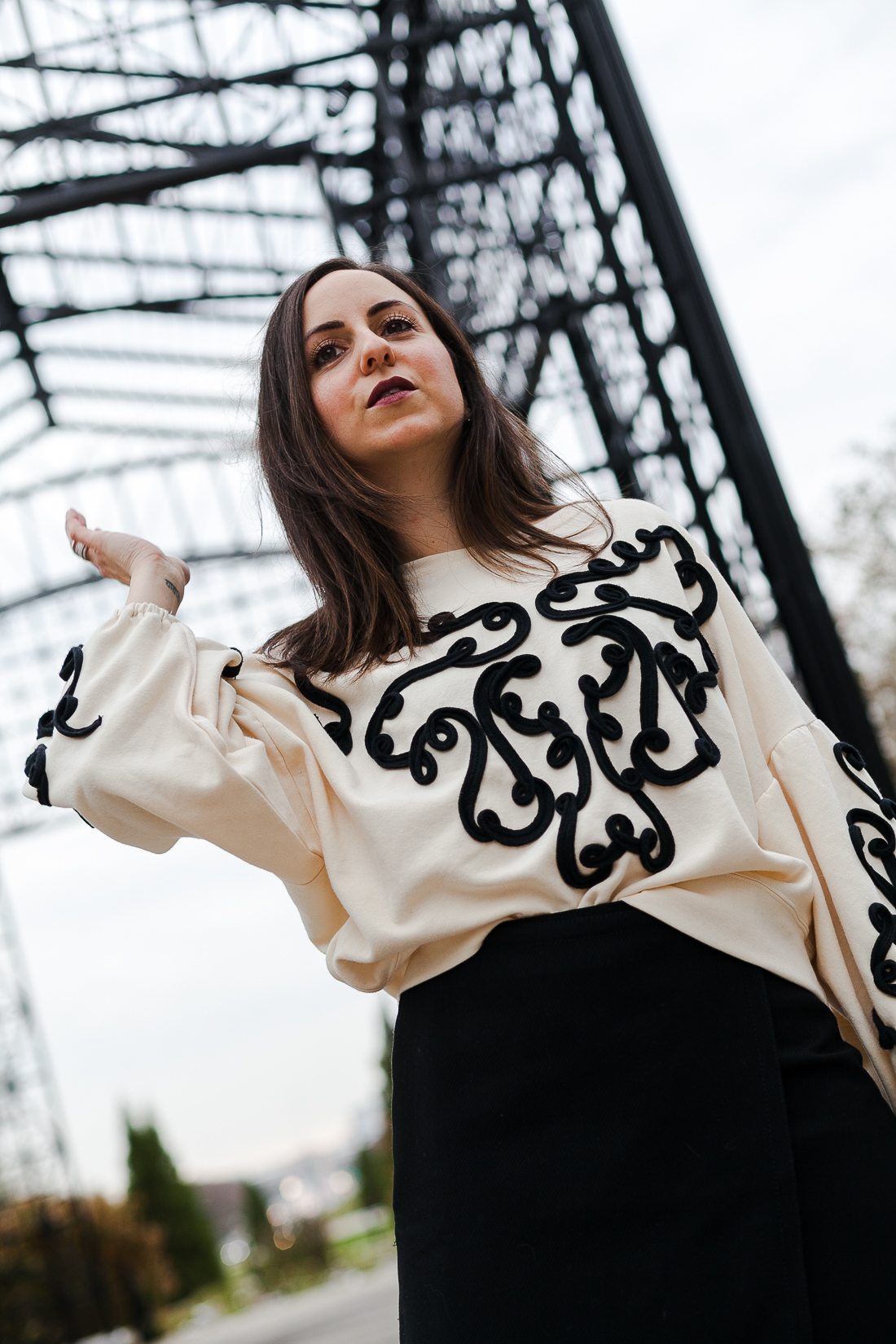 Yana Frigelis of NoMad Luxuries wearing an embroidered sweatshirt from zara and over the knee boots for a simple yet statement making outfit 