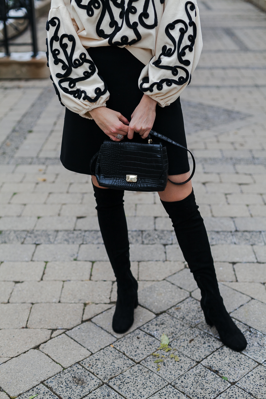 Yana Frigelis of NoMad Luxuries wearing an embroidered sweatshirt from zara and over the knee boots for a simple yet statement making outfit 