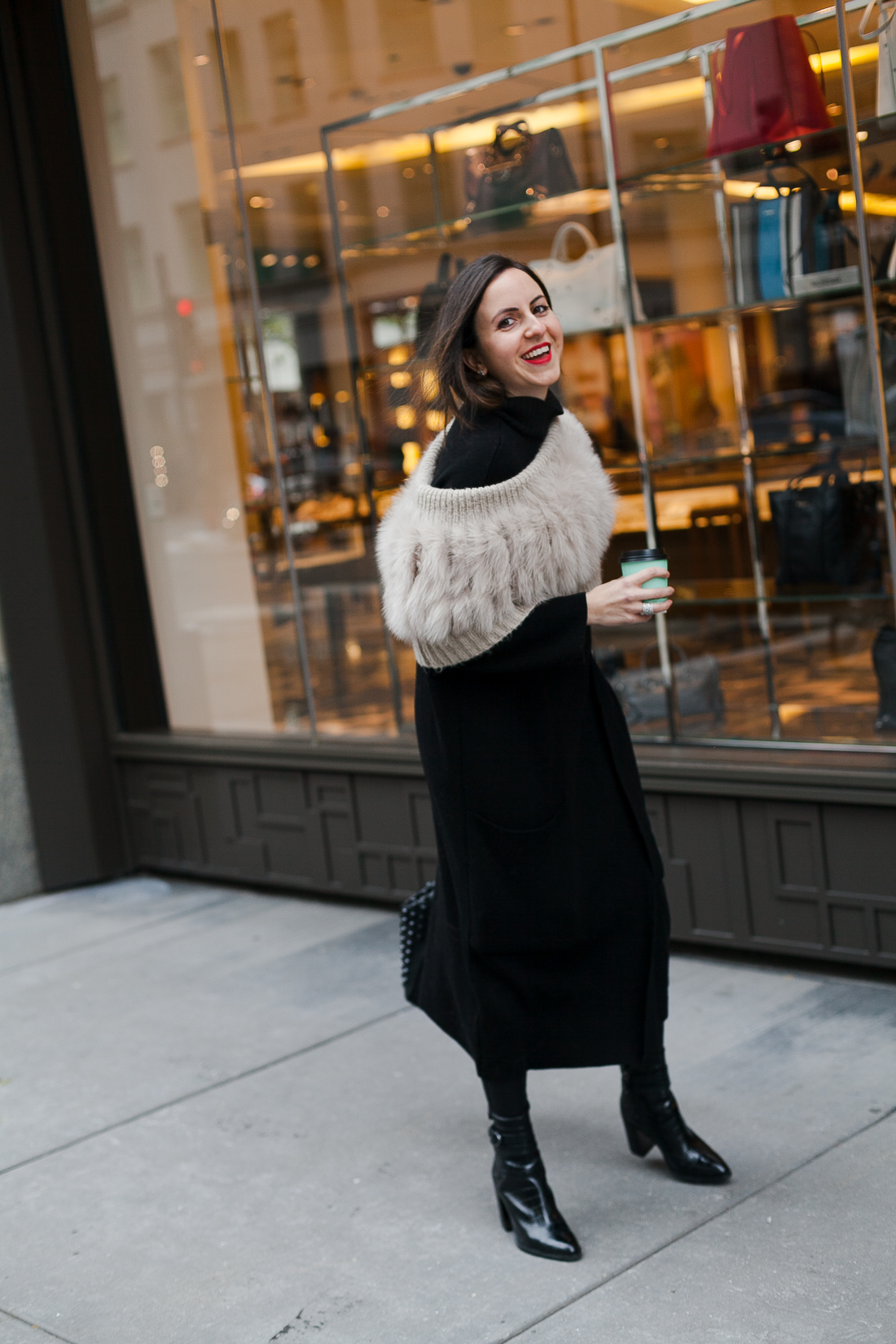 Yana Frigelis of NoMad Luxuries wearing an all black french-inspired look with a fur stole from mango